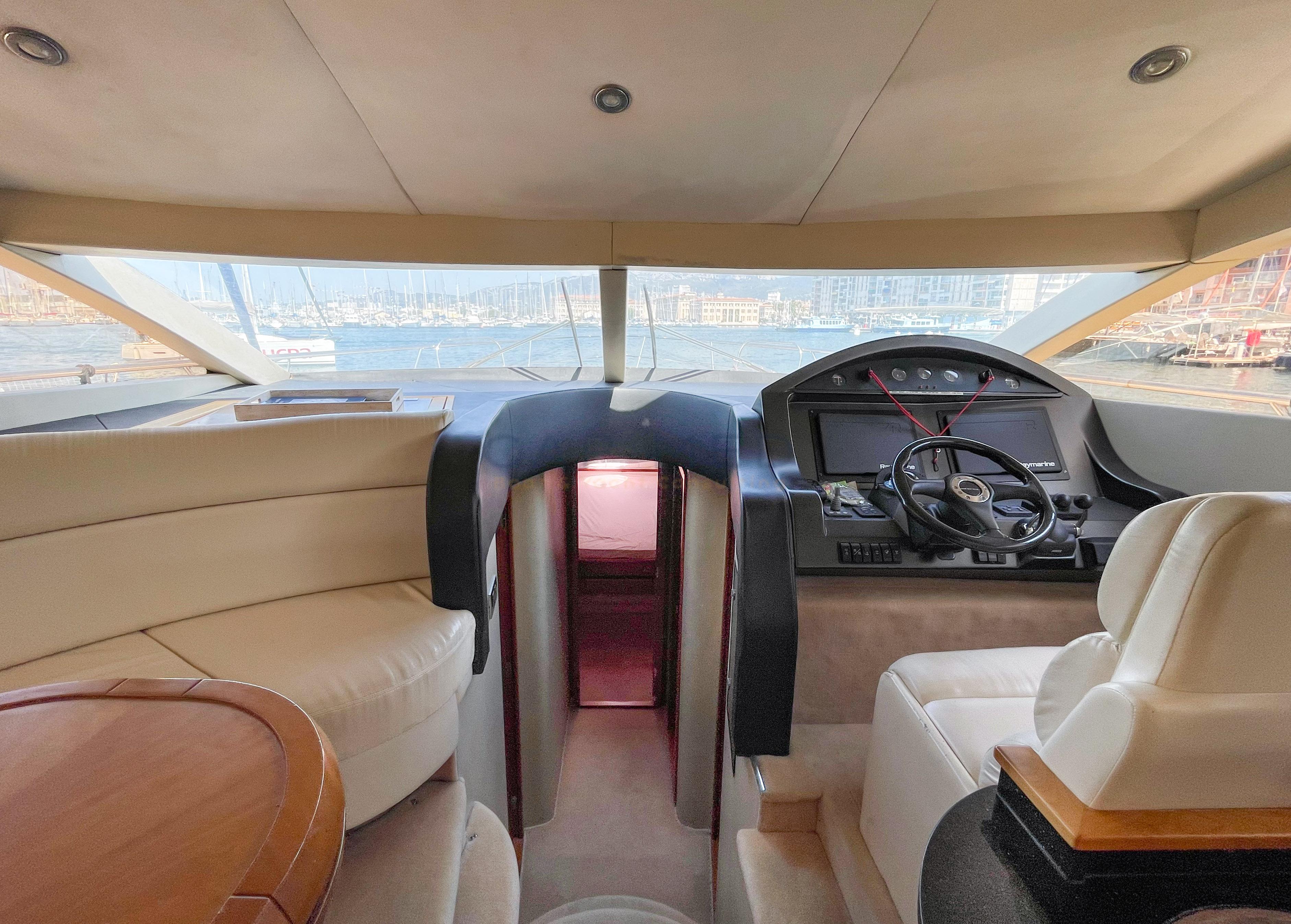 Interior view of a 2006 Pearl 60 yacht, featuring a luxurious helm and seating area.