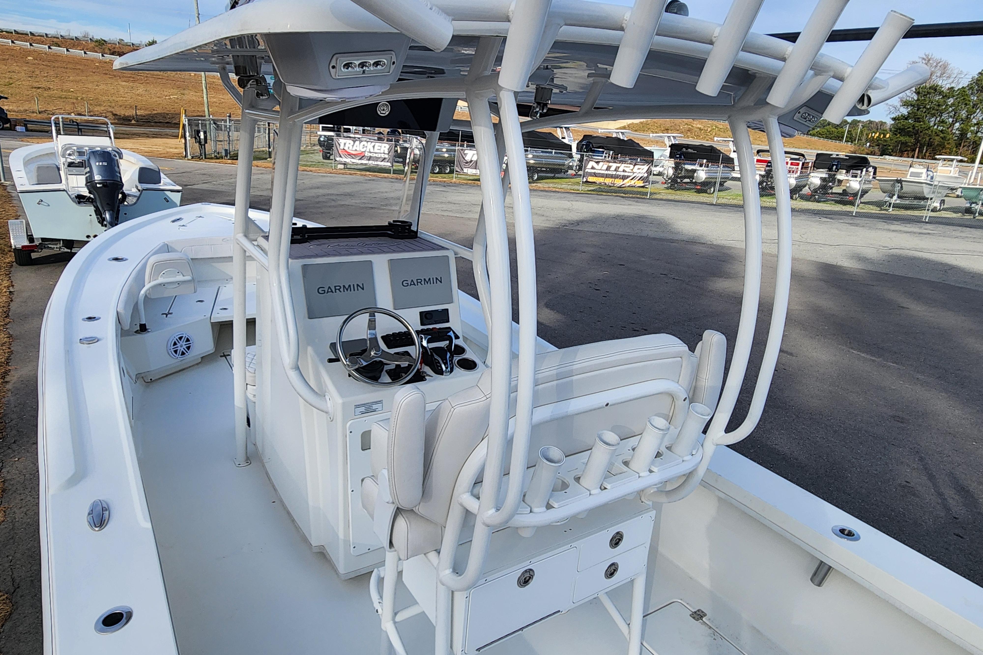 2024 Pair Customs 27 CC boat with Garmin navigation, docked outdoors.