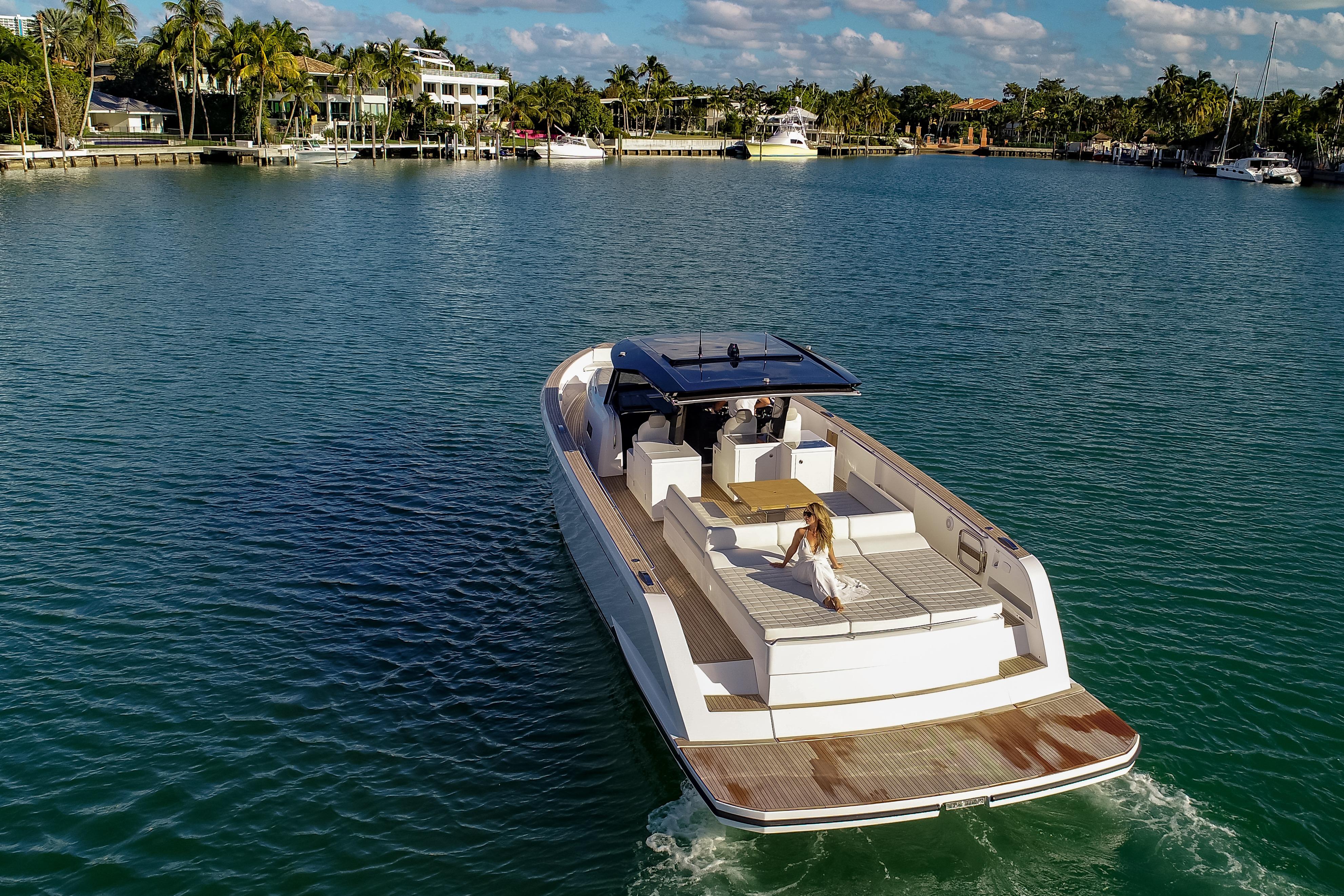 Luxury 2025 Pardo Yachts 50 cruising in serene waters, surrounded by lush greenery.