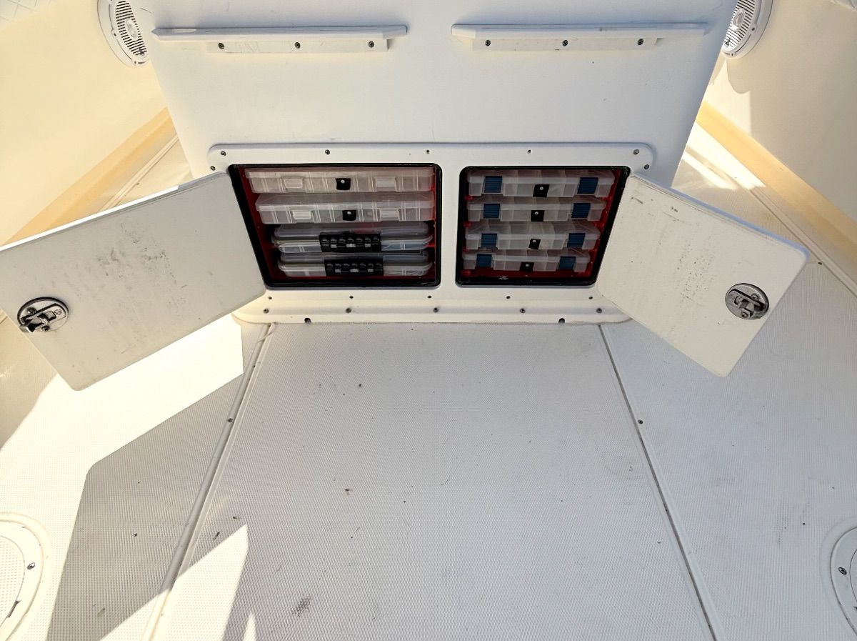 2004 World Cat 270TE storage compartments open on deck.