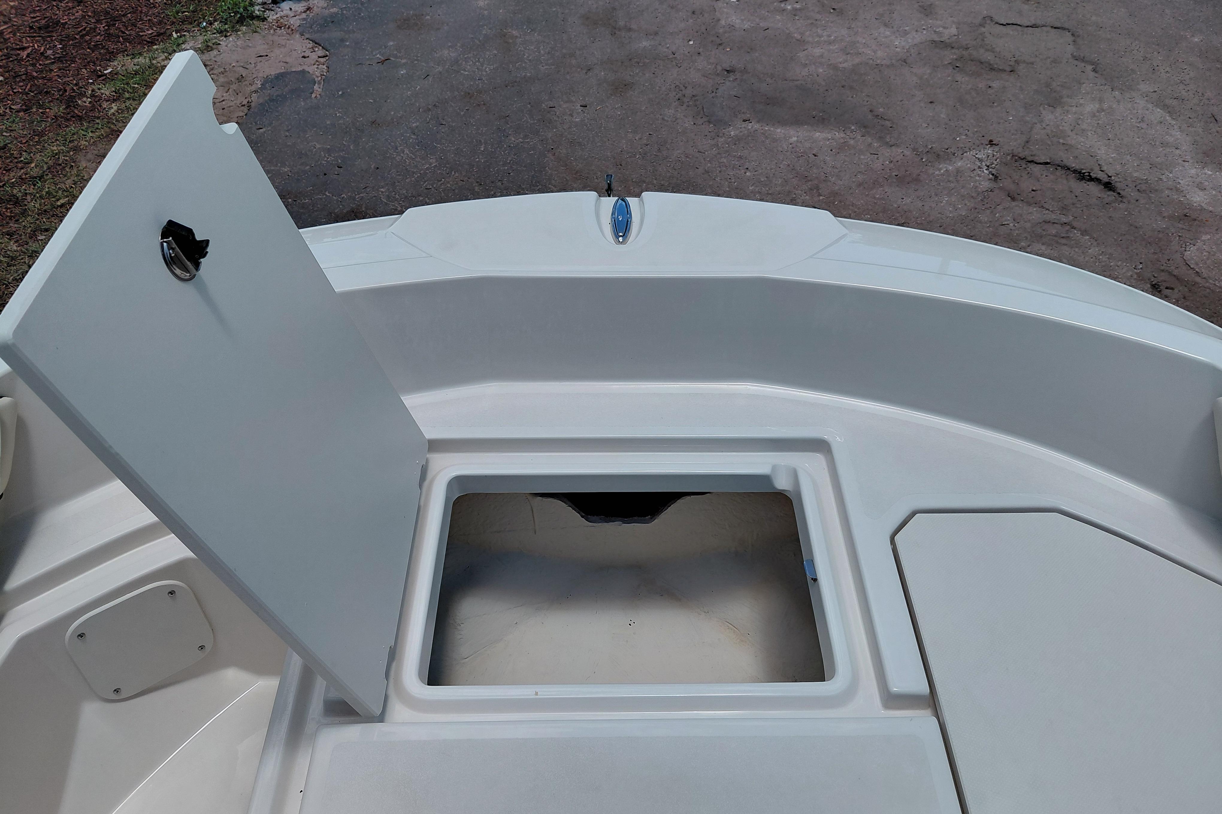 Open storage compartment on 2023 Stingray 206 CC boat deck.