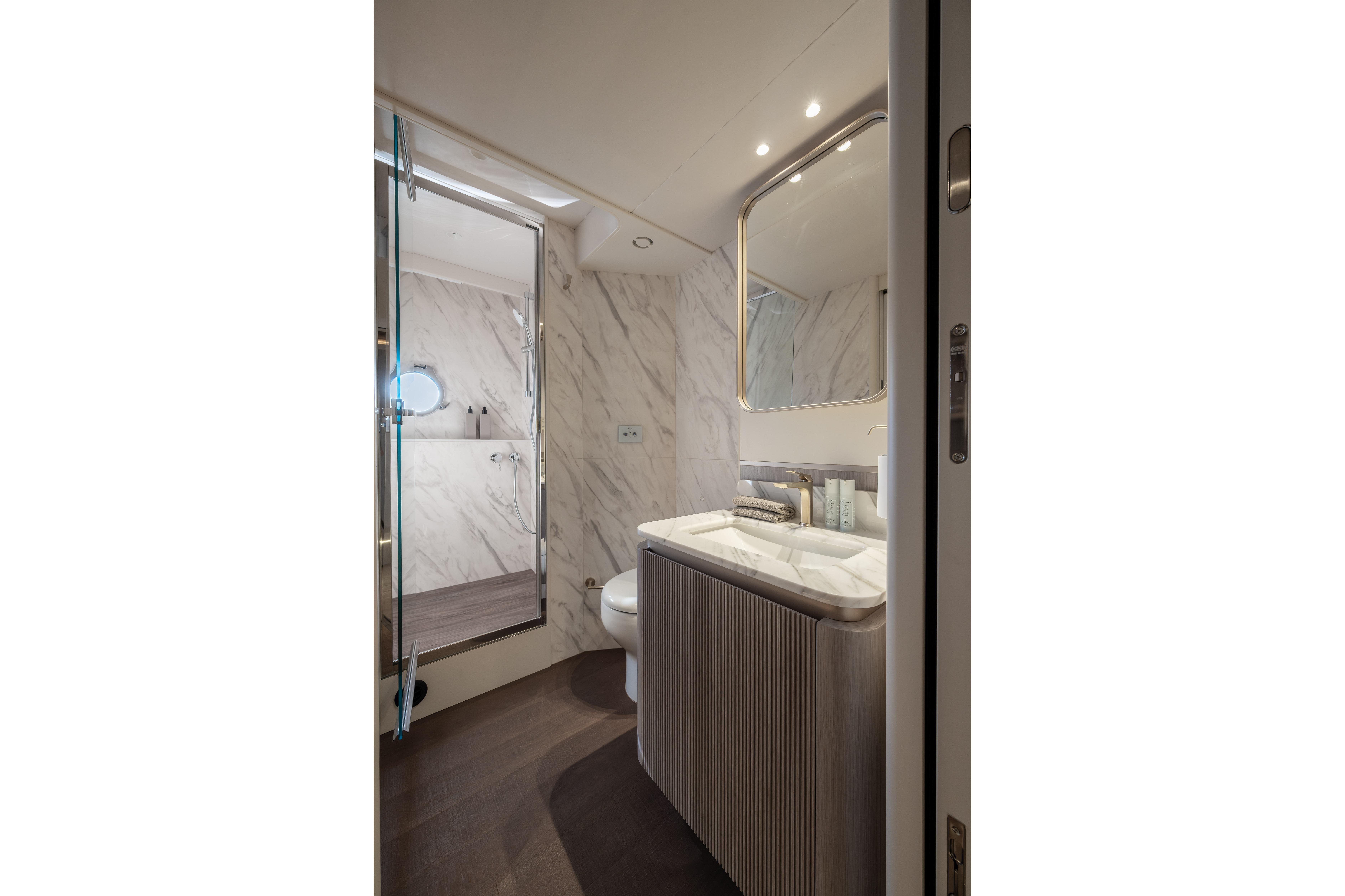 Luxurious bathroom with marble walls and modern fixtures on a yacht.