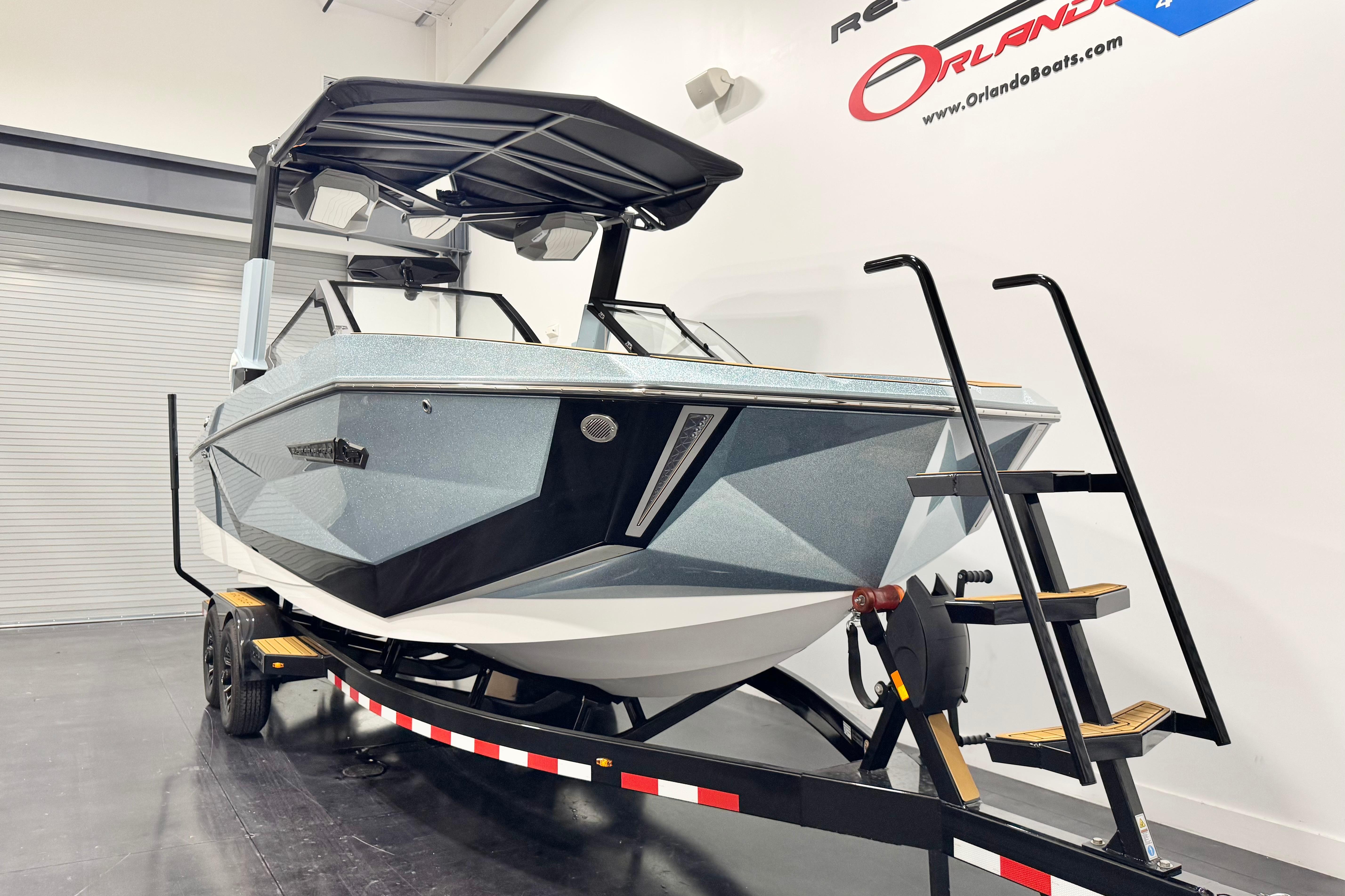 2026 Nautique Super Air Nautique G23 Paragon boat on trailer in showroom.