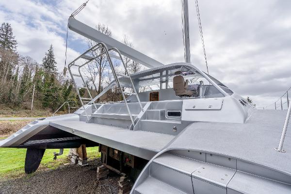 2025 Shuttleworth 52 AeroRig yacht with sleek design, docked outdoors under cloudy sky.