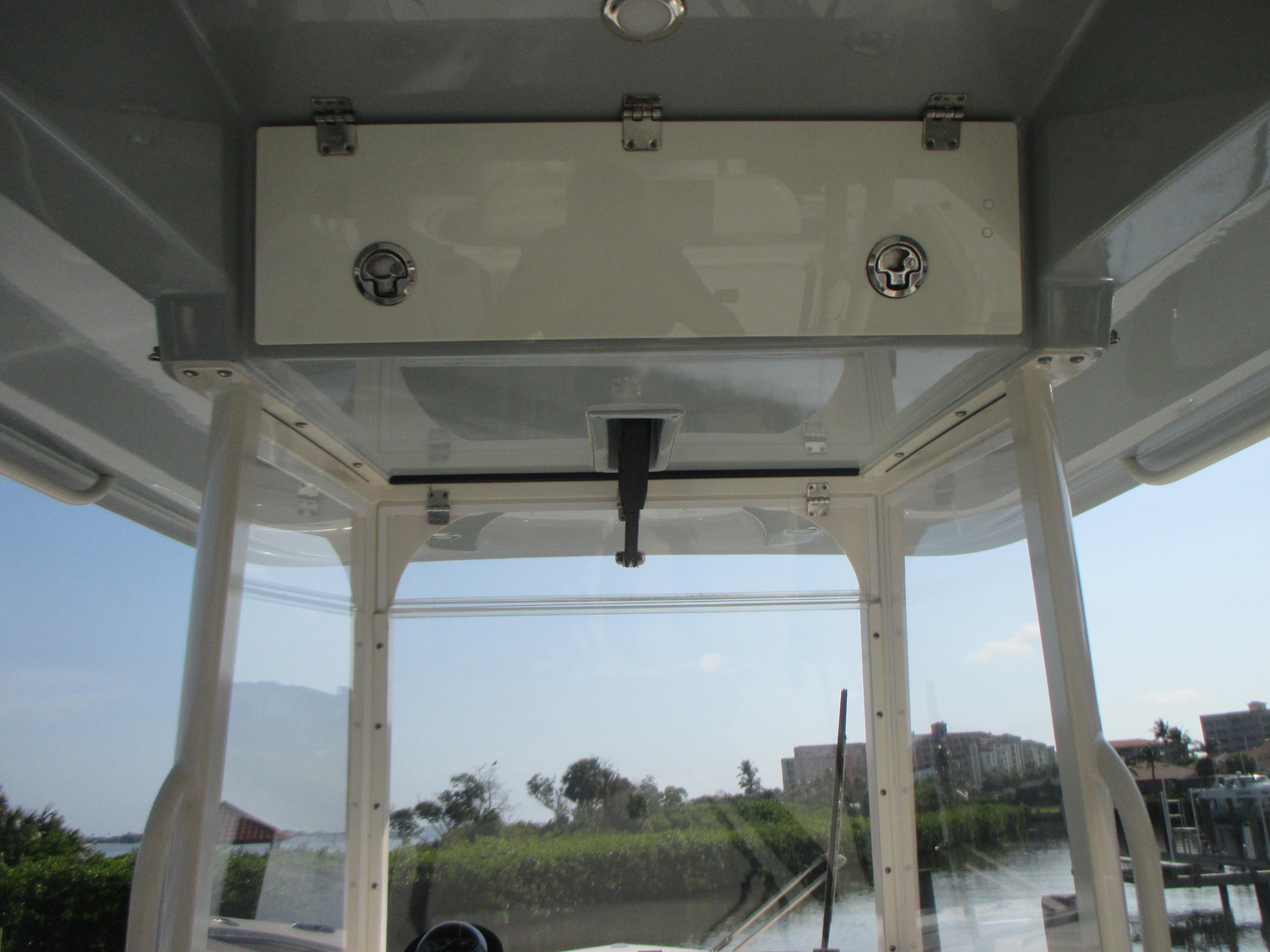 2018 Cobia 301 Center Console boat interior with storage compartment and clear view of waterway.