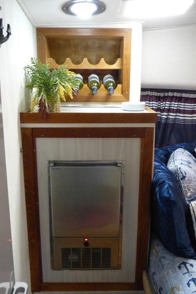 1989 Trojan 14 Meter Convertible interior with wine rack and cozy bedding.