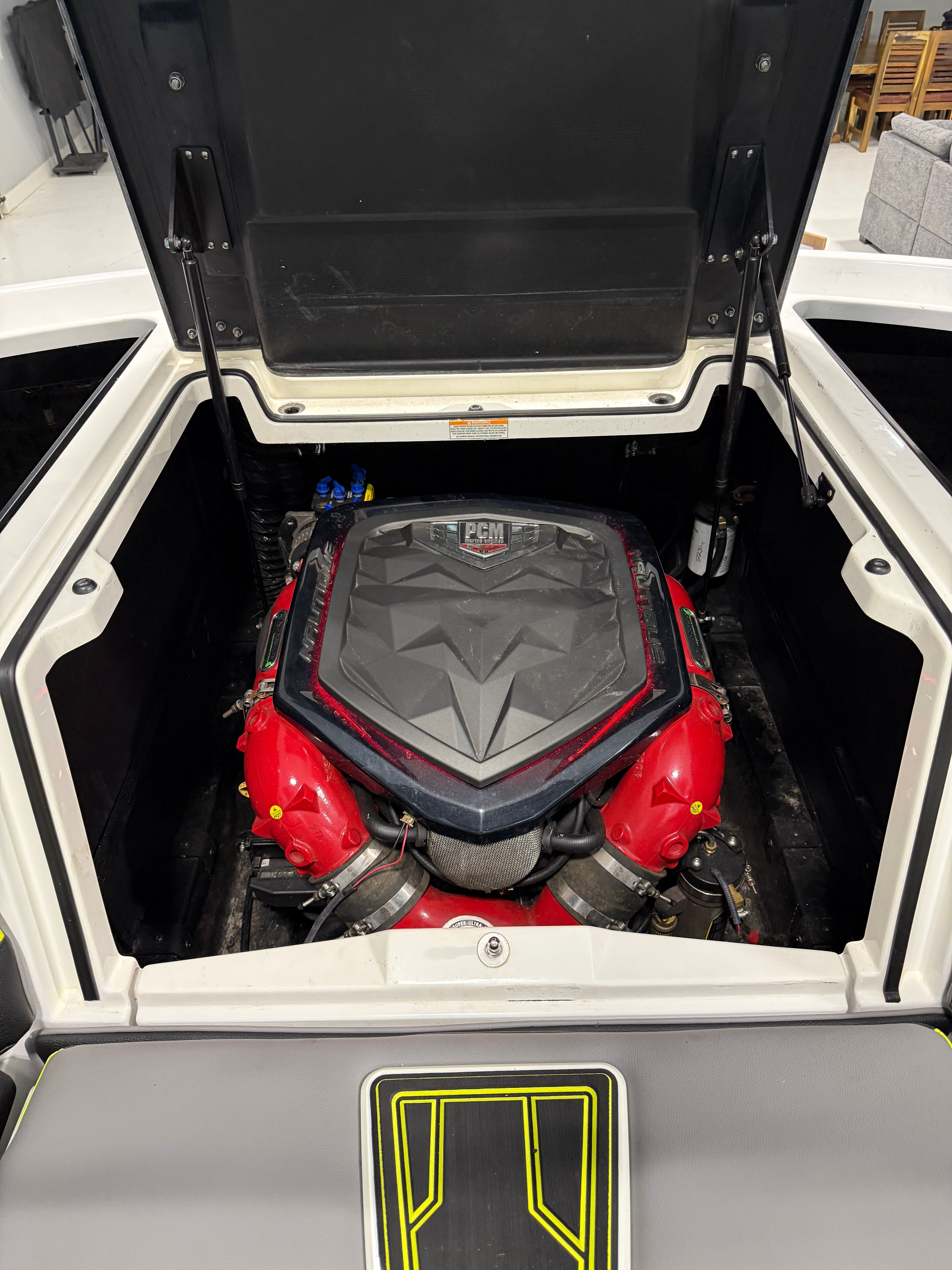 The engine compartment of a 2016 Nautique Super Air Nautique G23 with a powerful engine.
