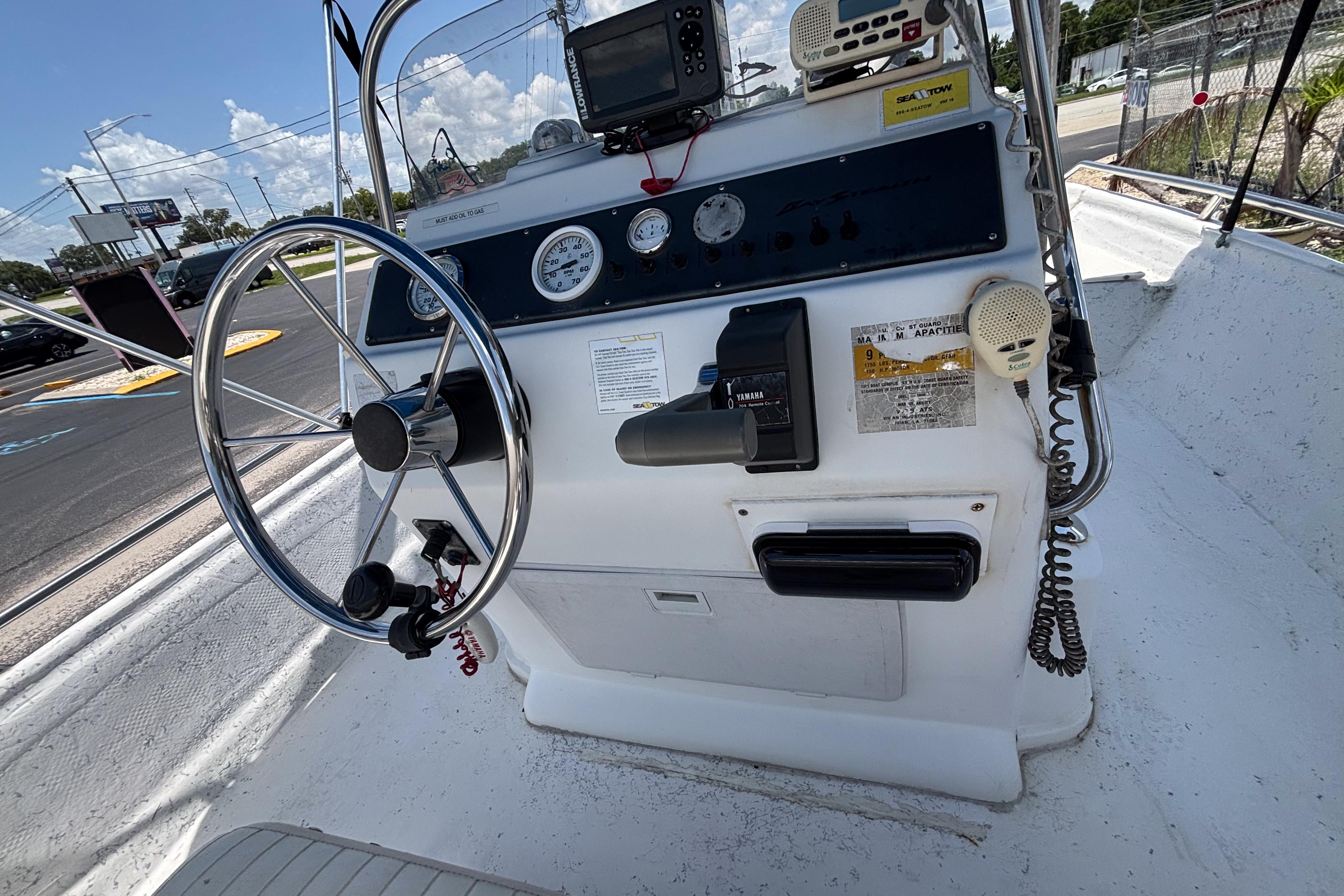 Steering console of a 2000 VIP 1880 BAY STEALTH boat with gauges and controls.