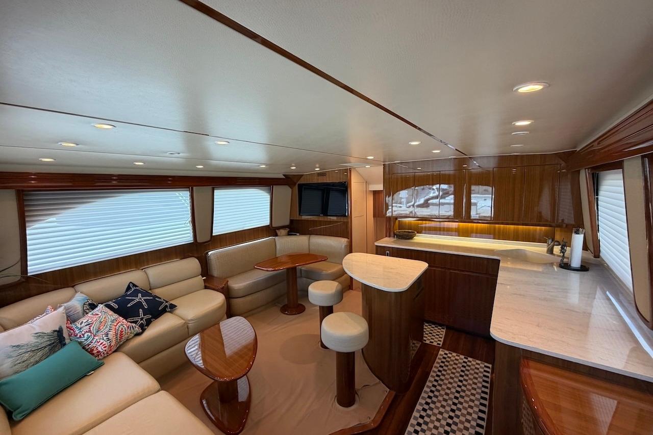 Luxurious interior of a 2012 Viking 50 Convertible yacht with elegant seating and modern kitchen.