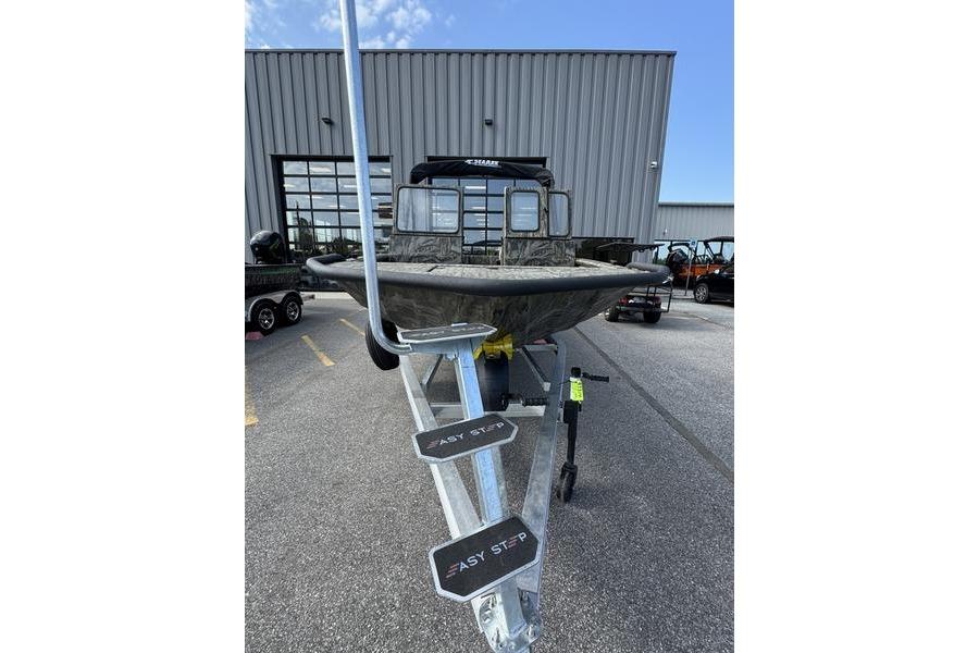 2025 SeaArk Predator 300 AK boat on trailer, parked outside a building.