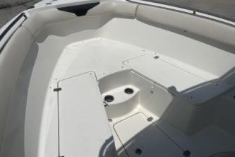 2023 Sailfish 242 CC boat interior with white seating and storage compartments.