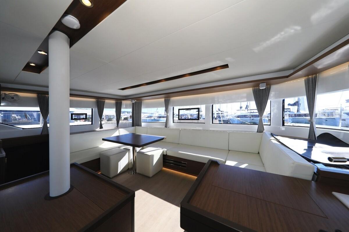 Spacious interior of 2021 Lagoon 50 catamaran with modern furnishings and large windows.