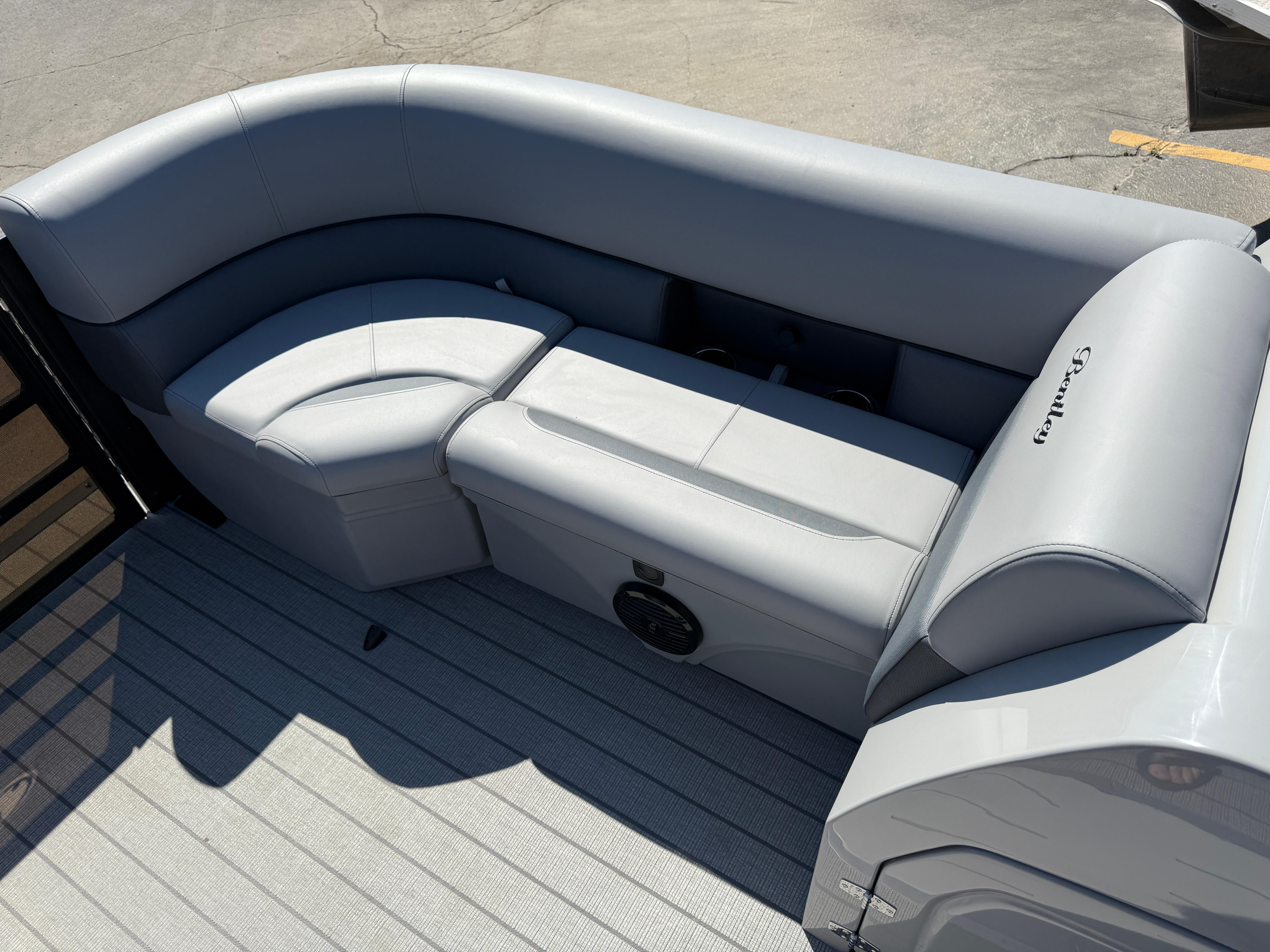 Luxurious seating on 2026 Bentley Pontoons Legacy 223 Navigator, featuring sleek gray upholstery.