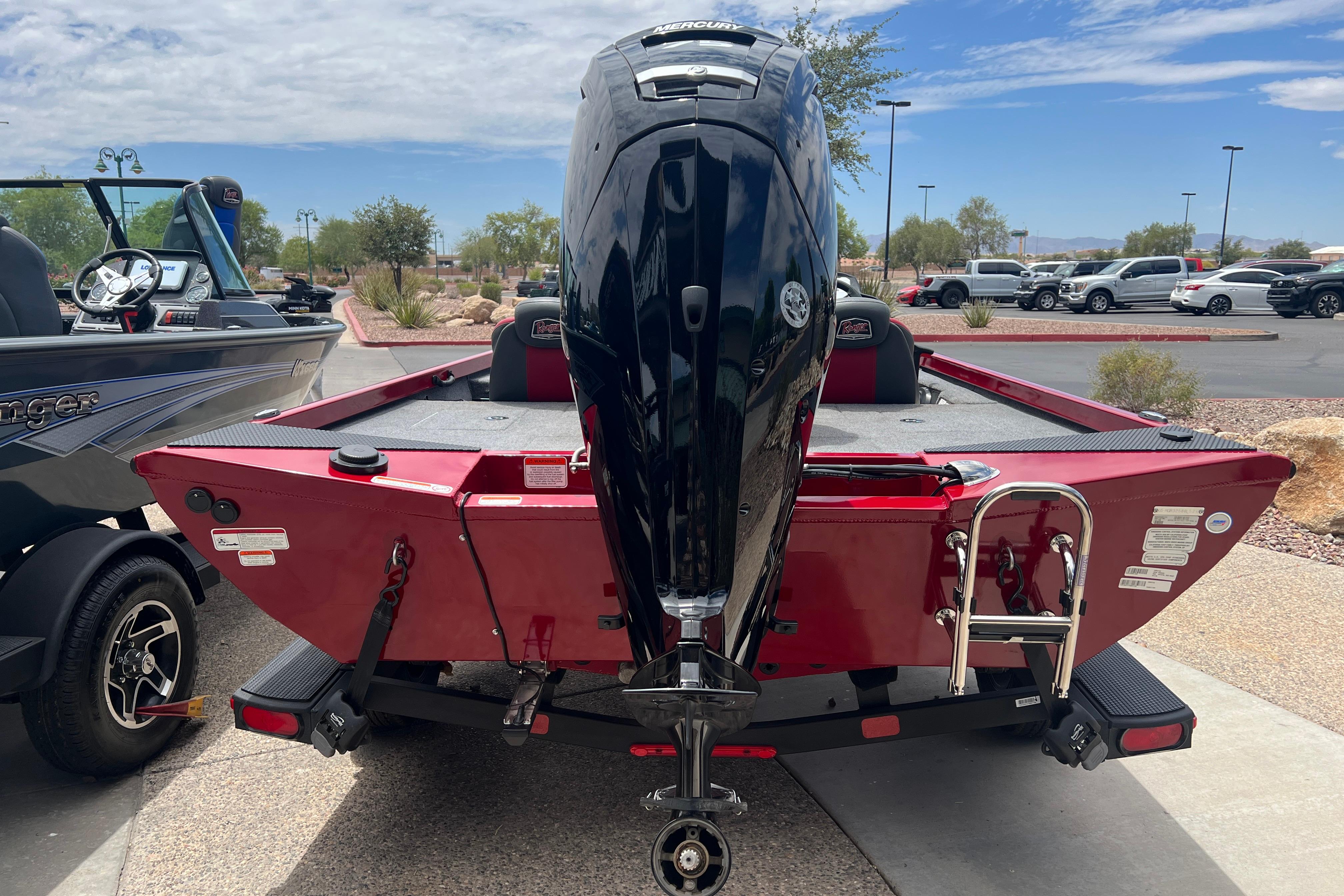 2026 Ranger RT178 boat with powerful outboard motor, parked outdoors on a sunny day.