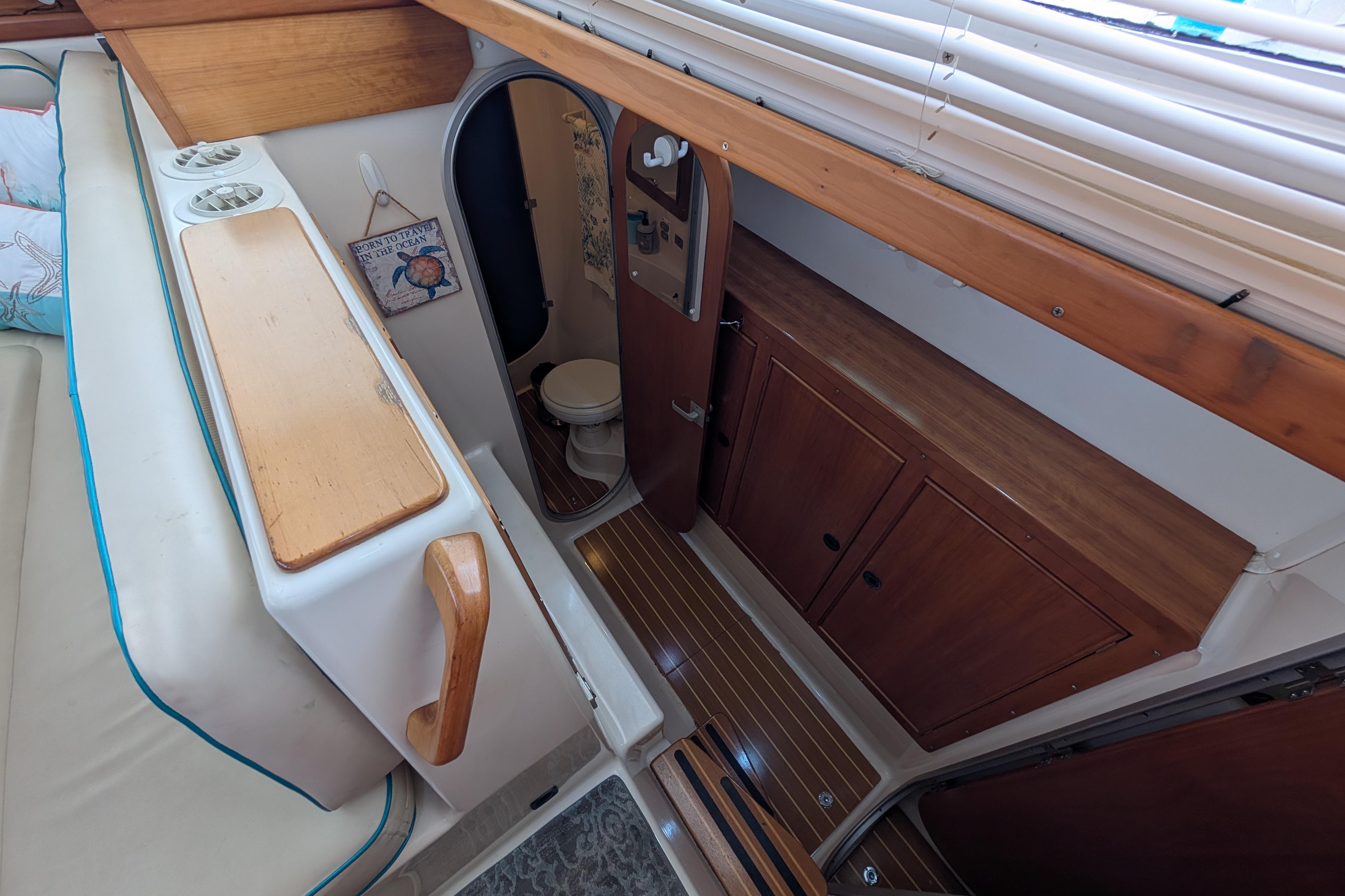 Interior of 2004 PDQ 34 Powercat showing cabin with seating and bathroom.