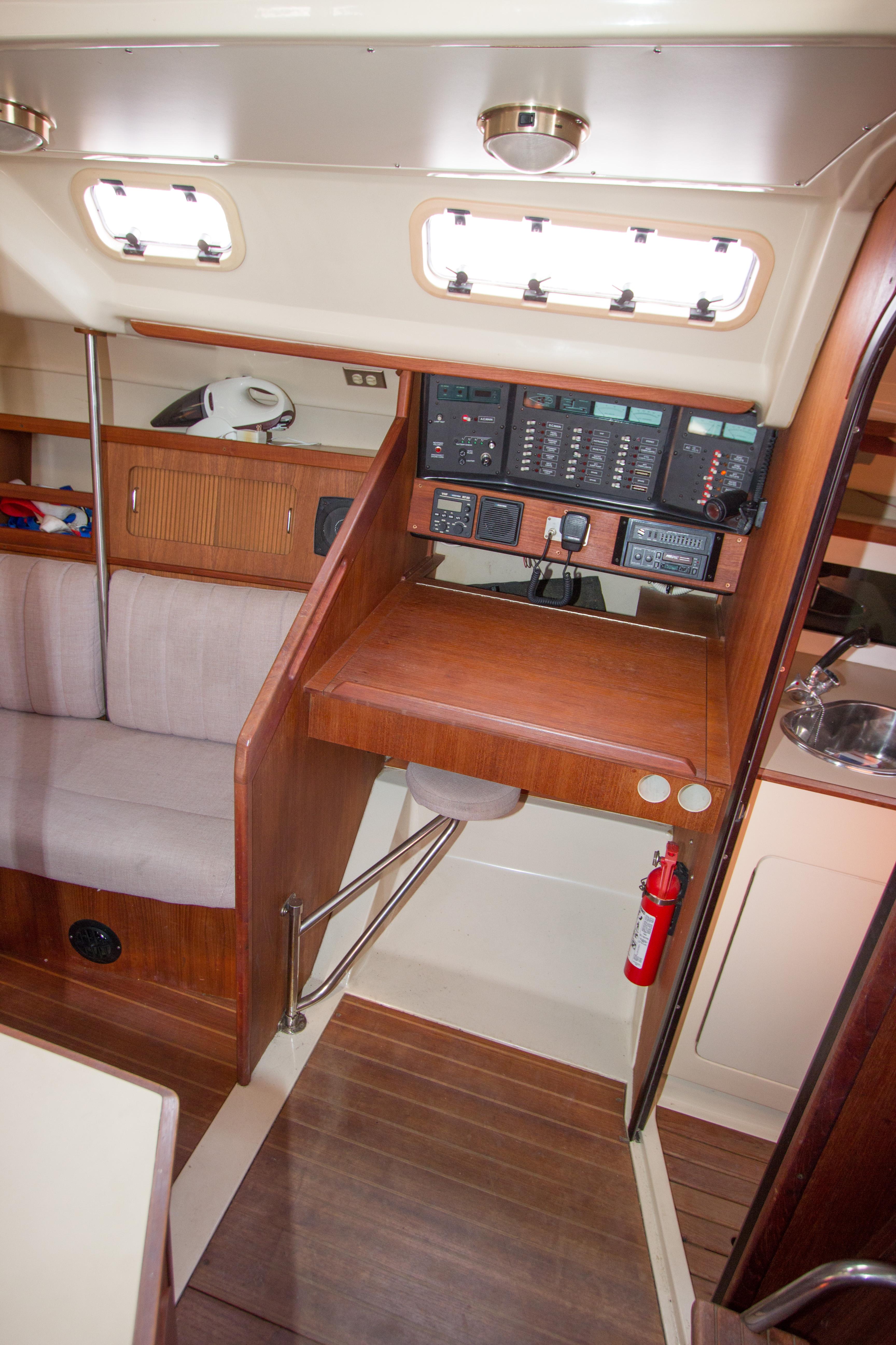 1989 Hunter 37.5 sloop interior with navigation station, seating, and wooden finishes.