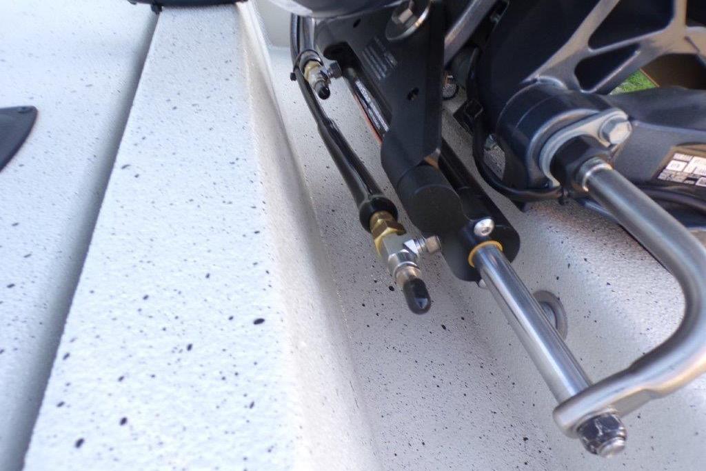 Close-up of 2026 Xpress H20B Bay boat's steering mechanism and hydraulic components.