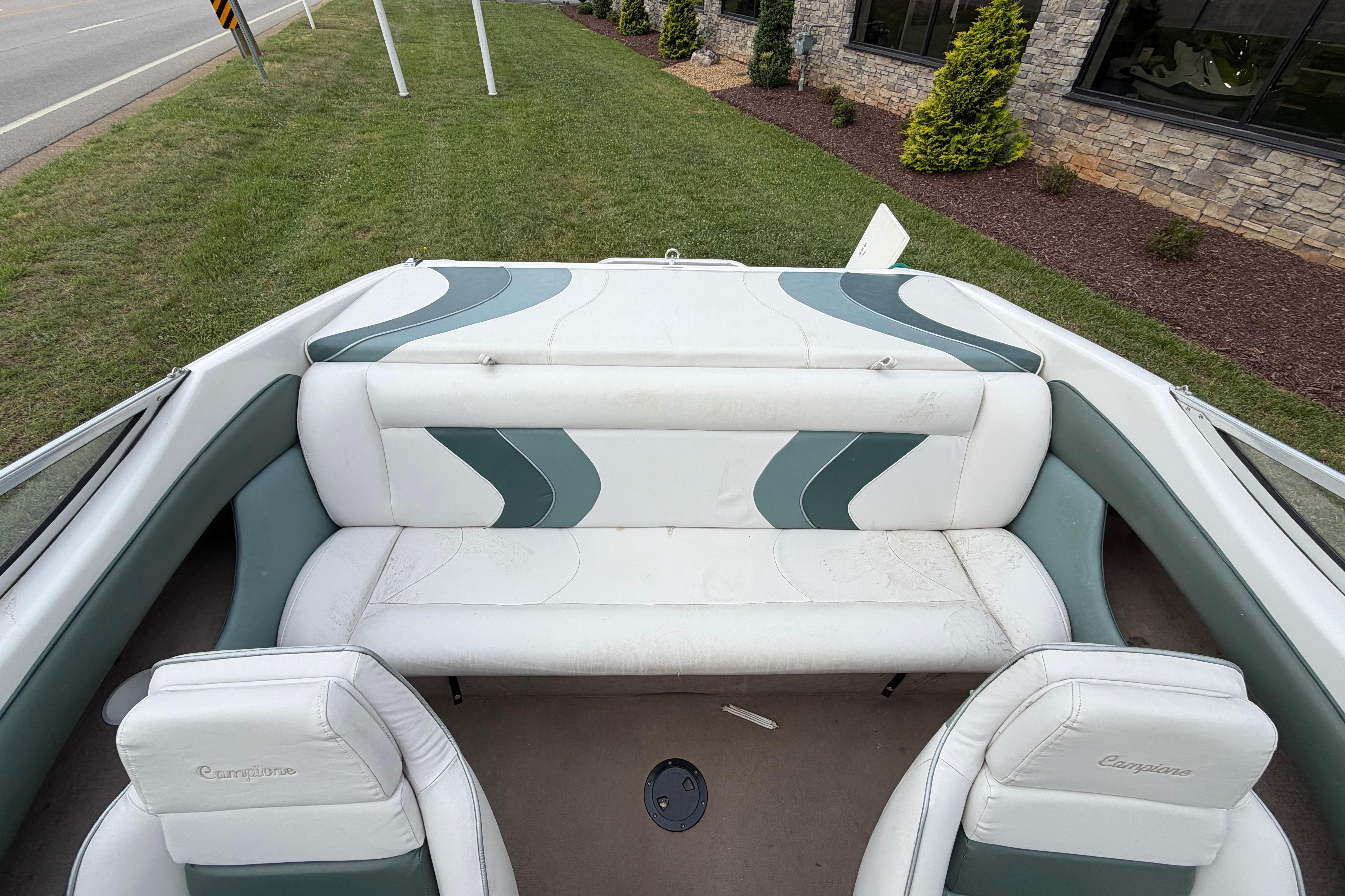 2001 Ebbtide Campione 190 boat interior with white and green seating, parked on grass.