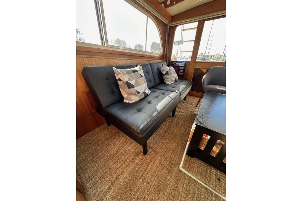 Interior of 1985 Egg Harbor 33 Sedan with modern sofa and geometric pillows.