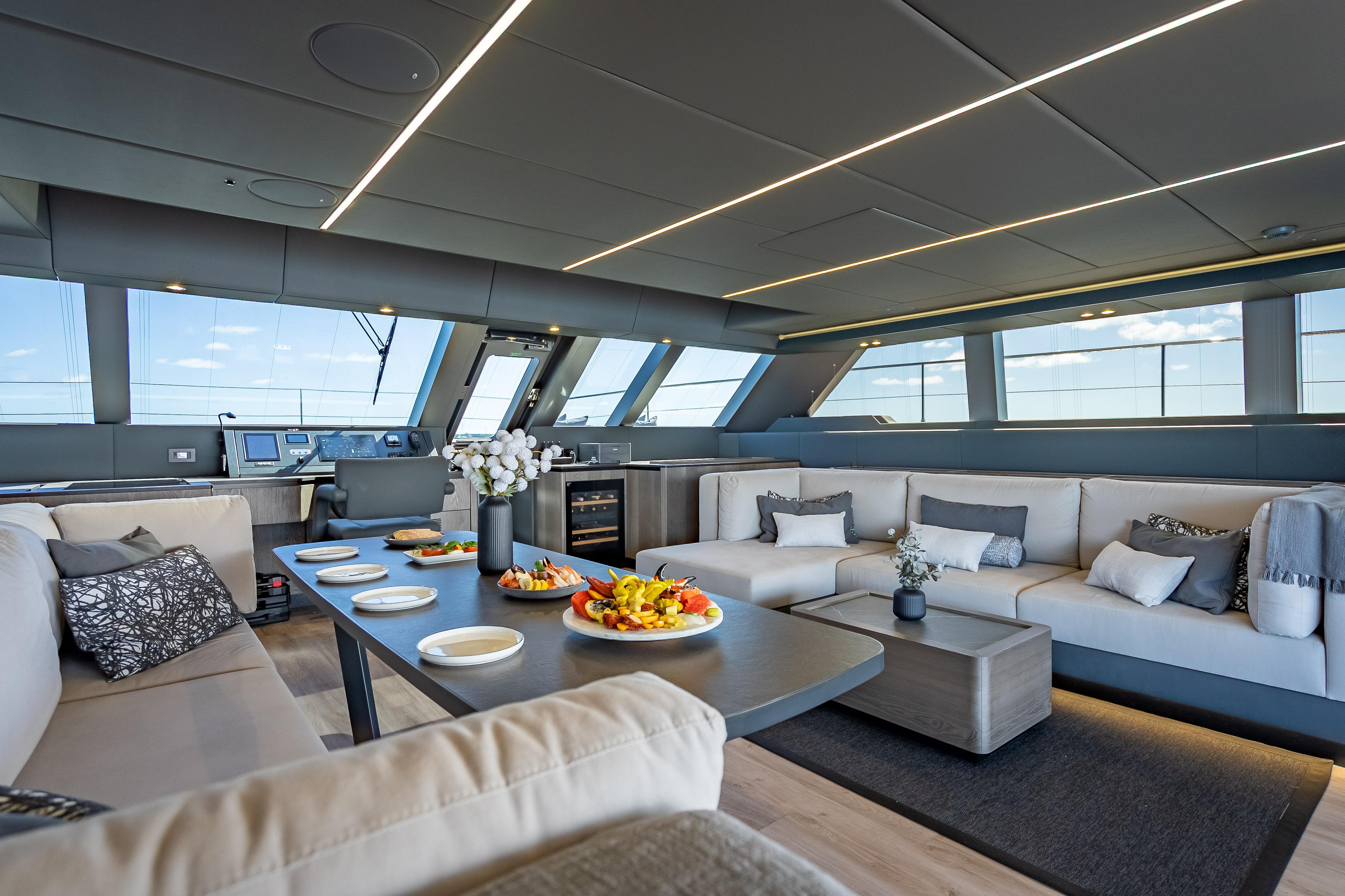 Luxurious interior of 2026 Sunreef 60 Power yacht with elegant seating and dining area.