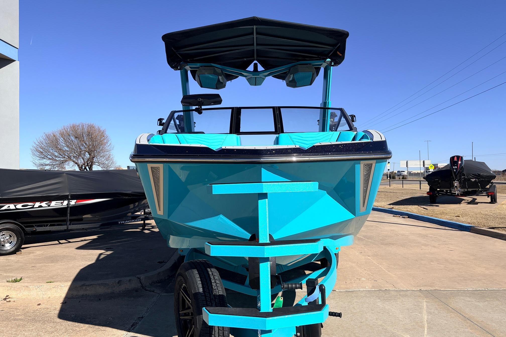 2026 Nautique Super Air Nautique G23 boat in vibrant blue on a trailer.