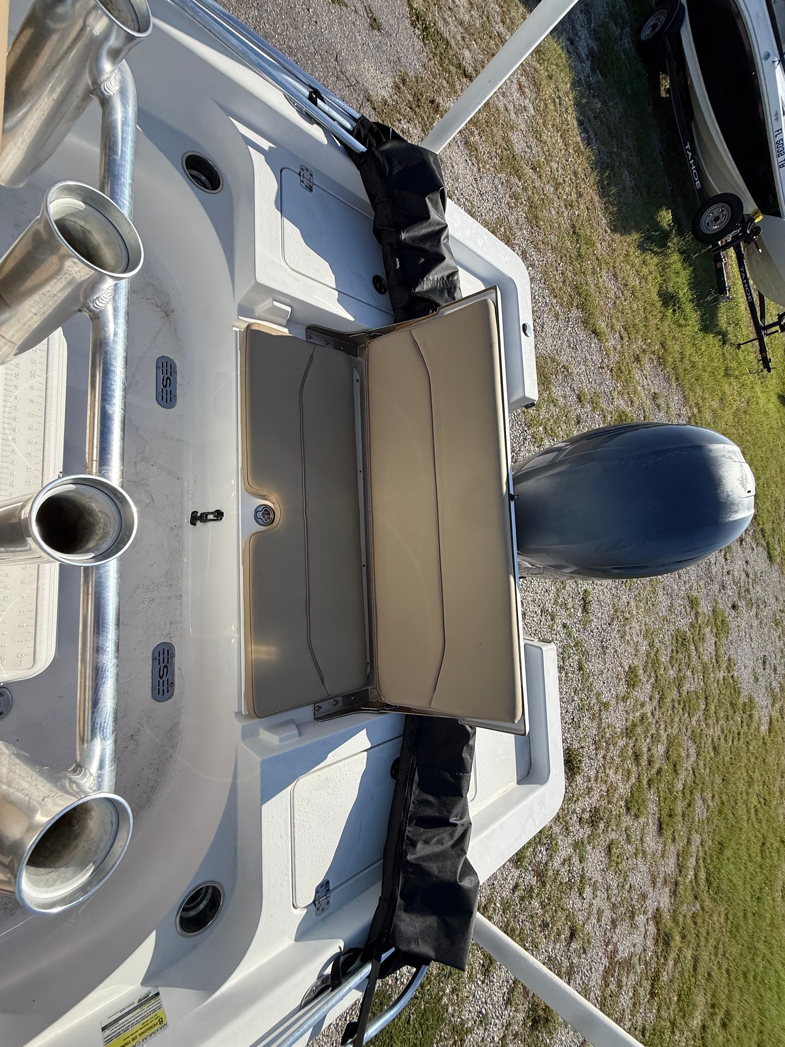 The image shows the stern of a Sportsman Masters 227 Bay Boat with an open storage compartment.
