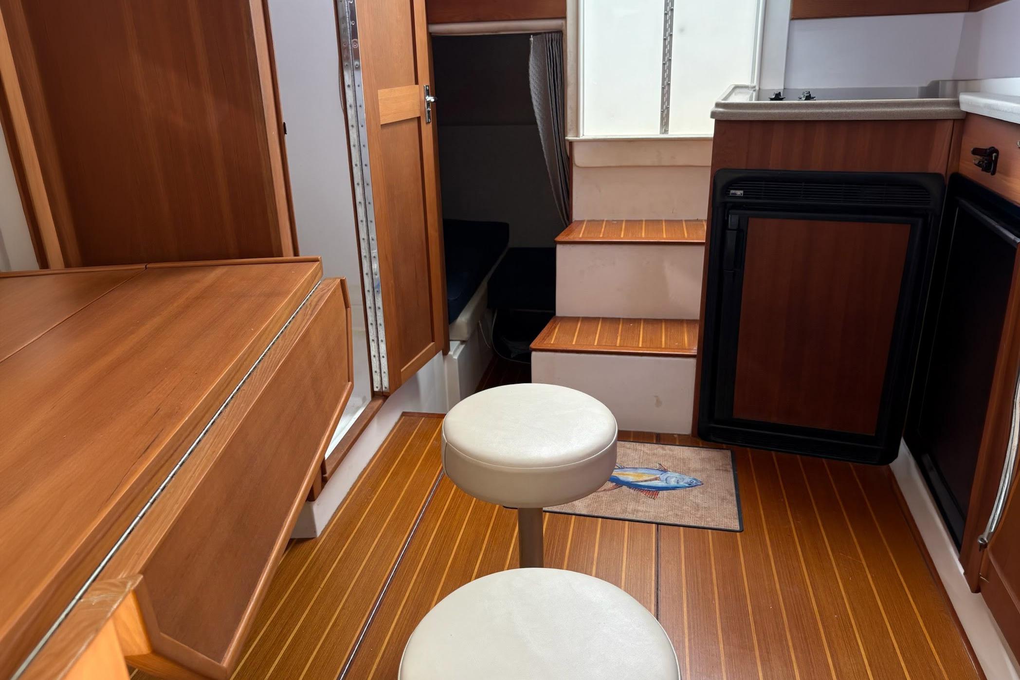 Interior of 2008 Stamas 370 Express boat with wooden cabinetry and seating.