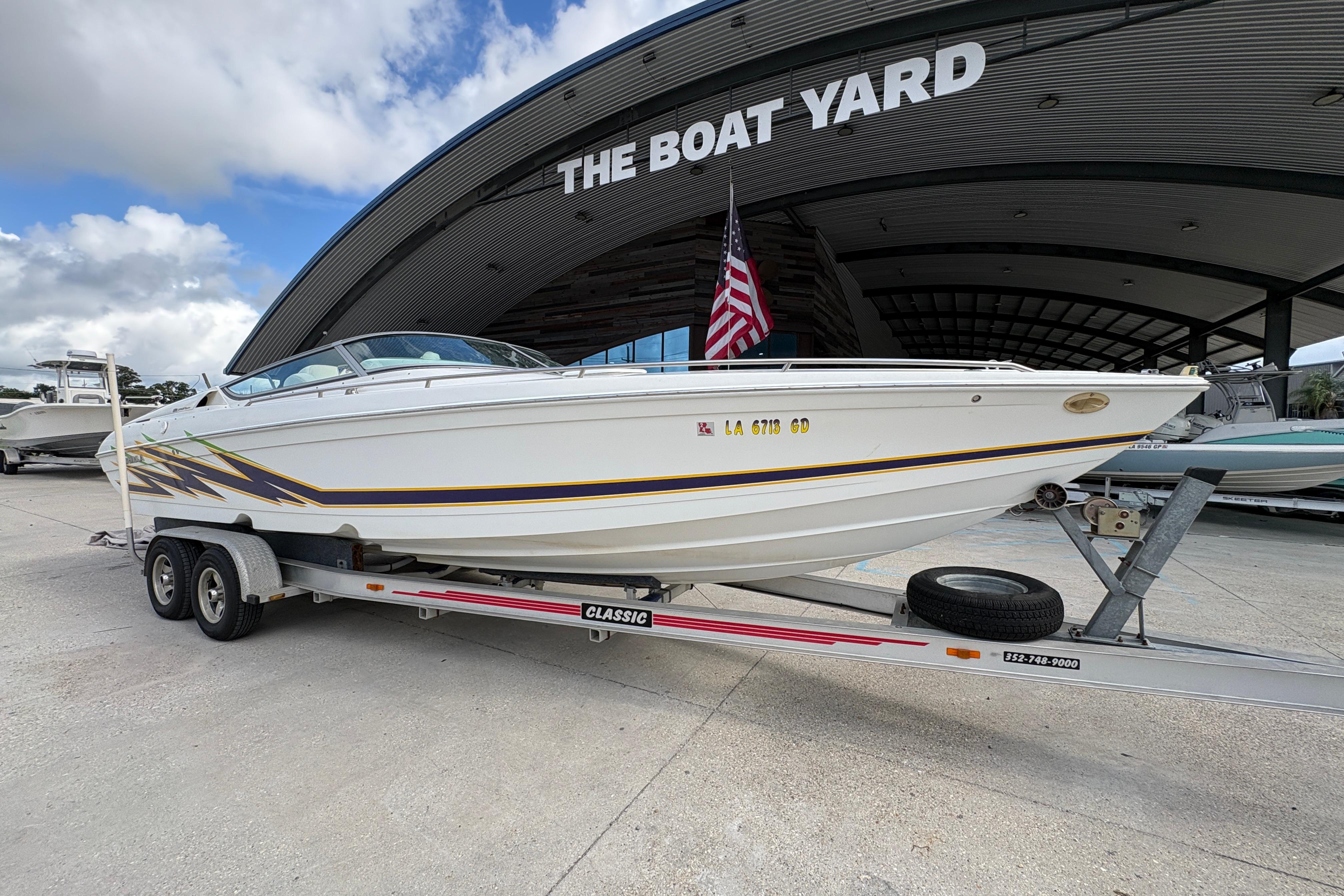 2002 Formula 292 FASTech boat on trailer at The Boat Yard, American flag displayed.