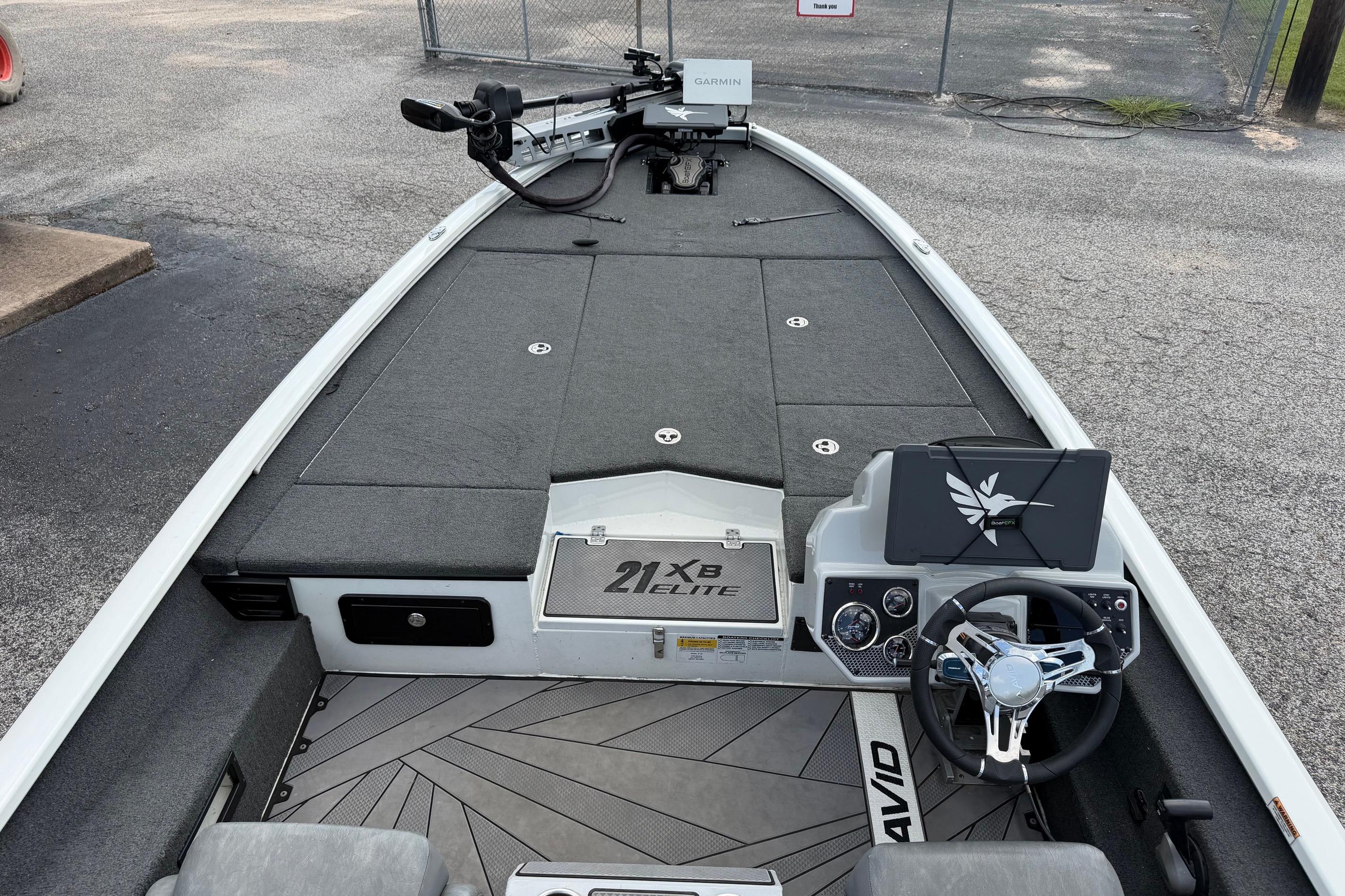 2024 Avid 21 XB Elite boat interior with steering wheel and Garmin electronics.