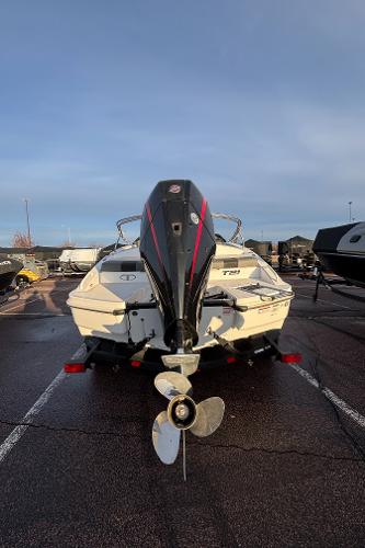2024 Tahoe T21 boat with outboard motor in a parking lot.