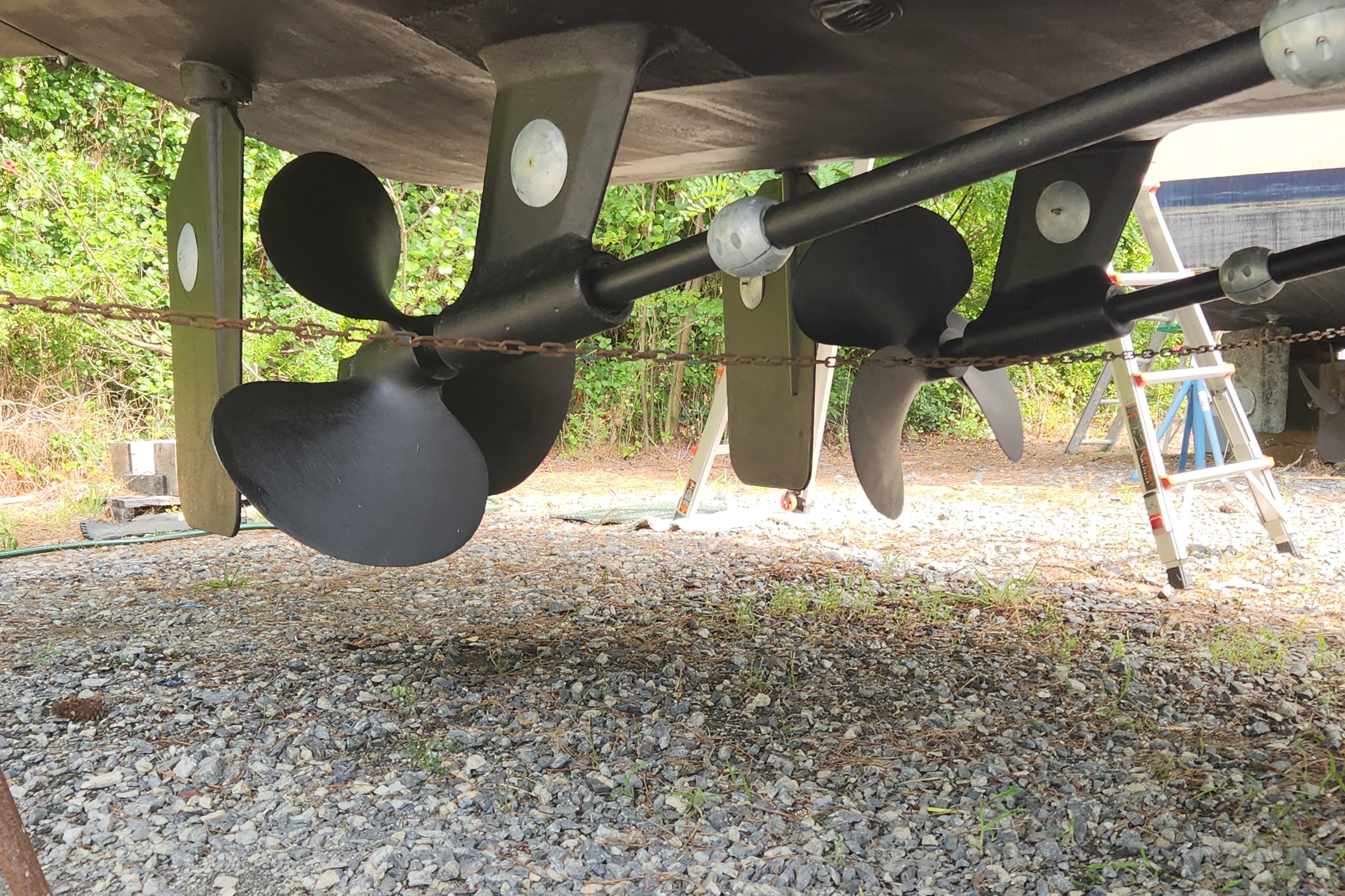 Underwater view of 2004 Grand Harbour 58 yacht propellers and rudders on gravel.