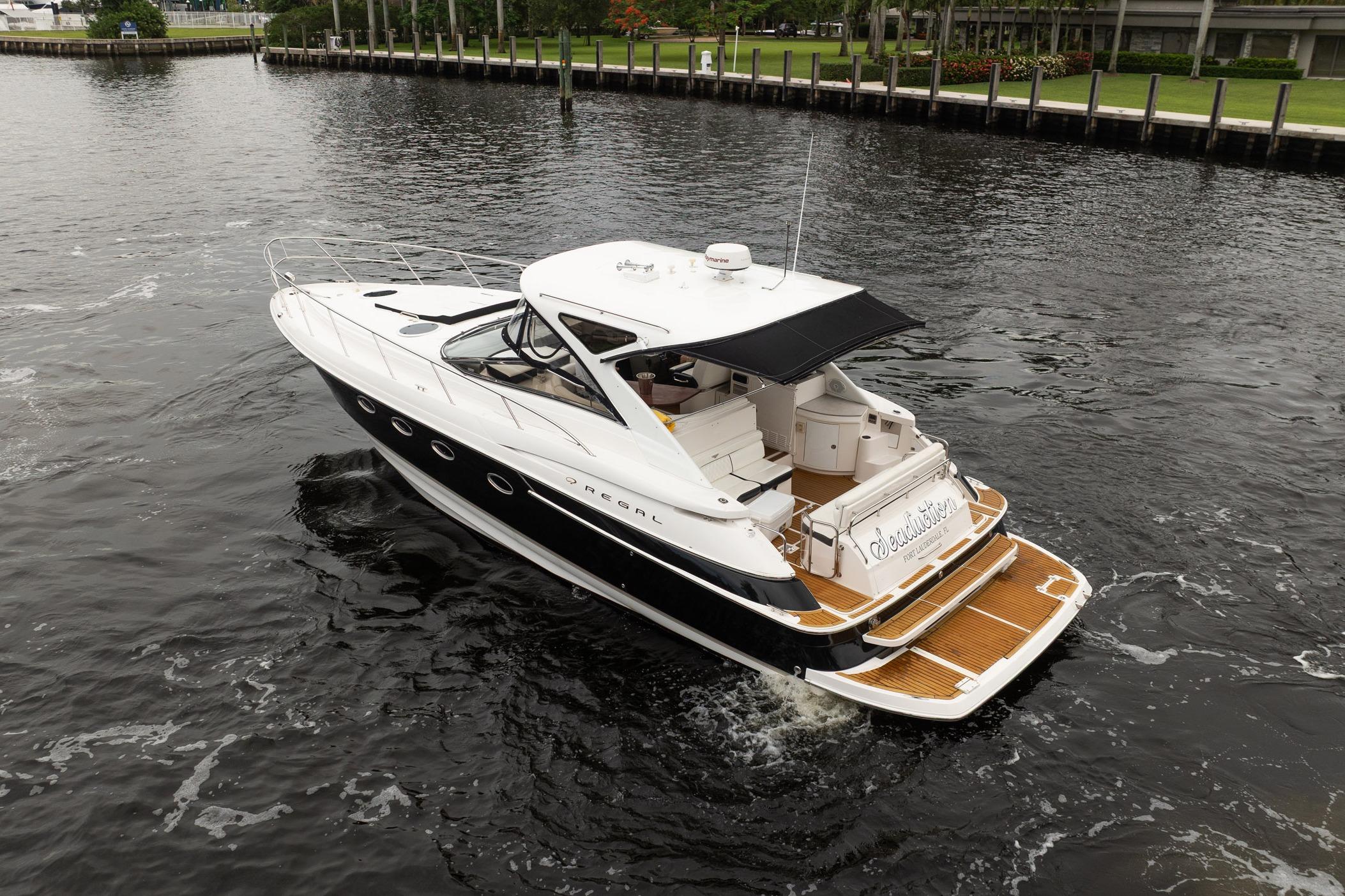 2008 Regal Commodore 4460 yacht cruising on a calm waterway.