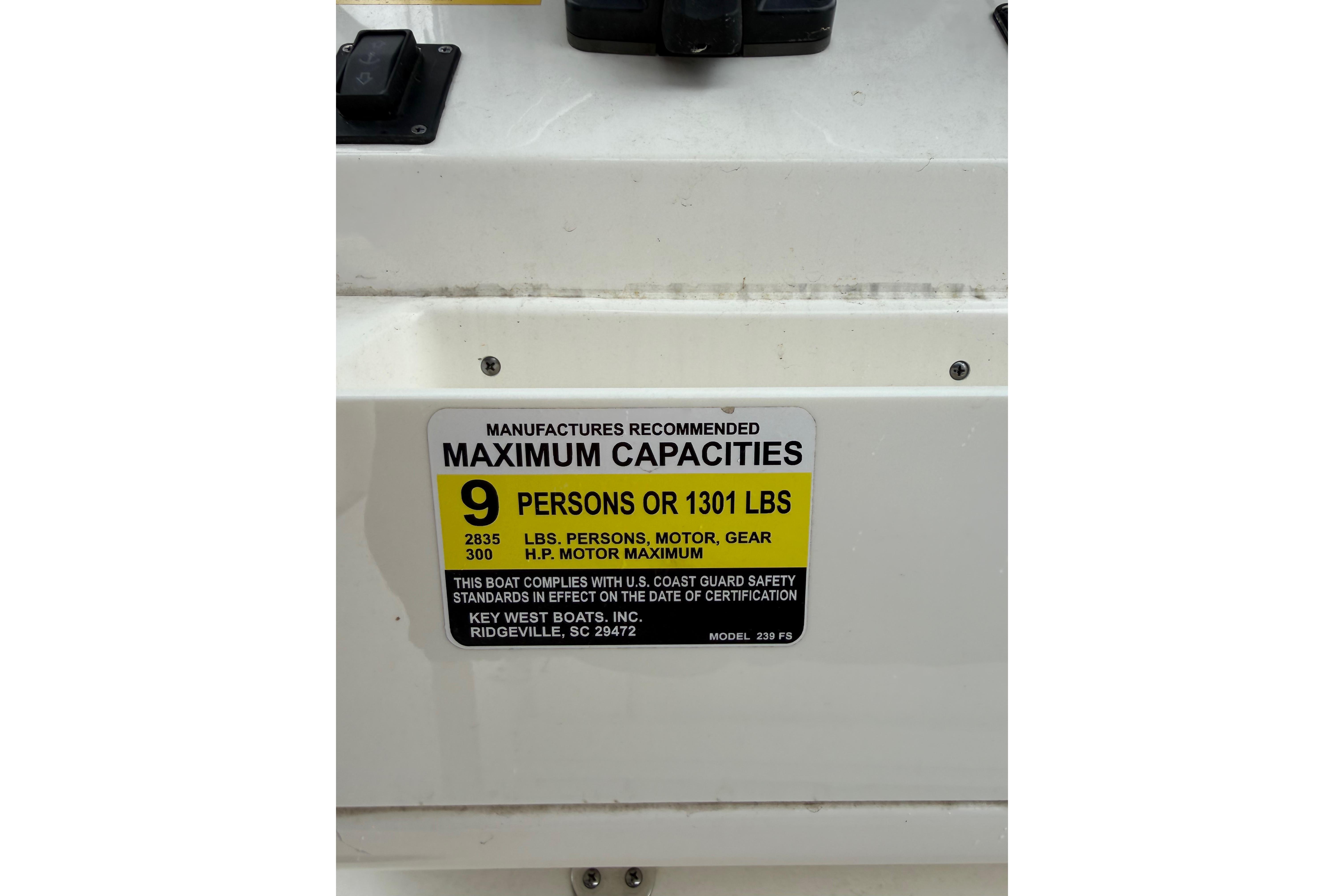 2022 Key West 239 FS boat capacity label, maximum 9 persons or 1301 lbs.