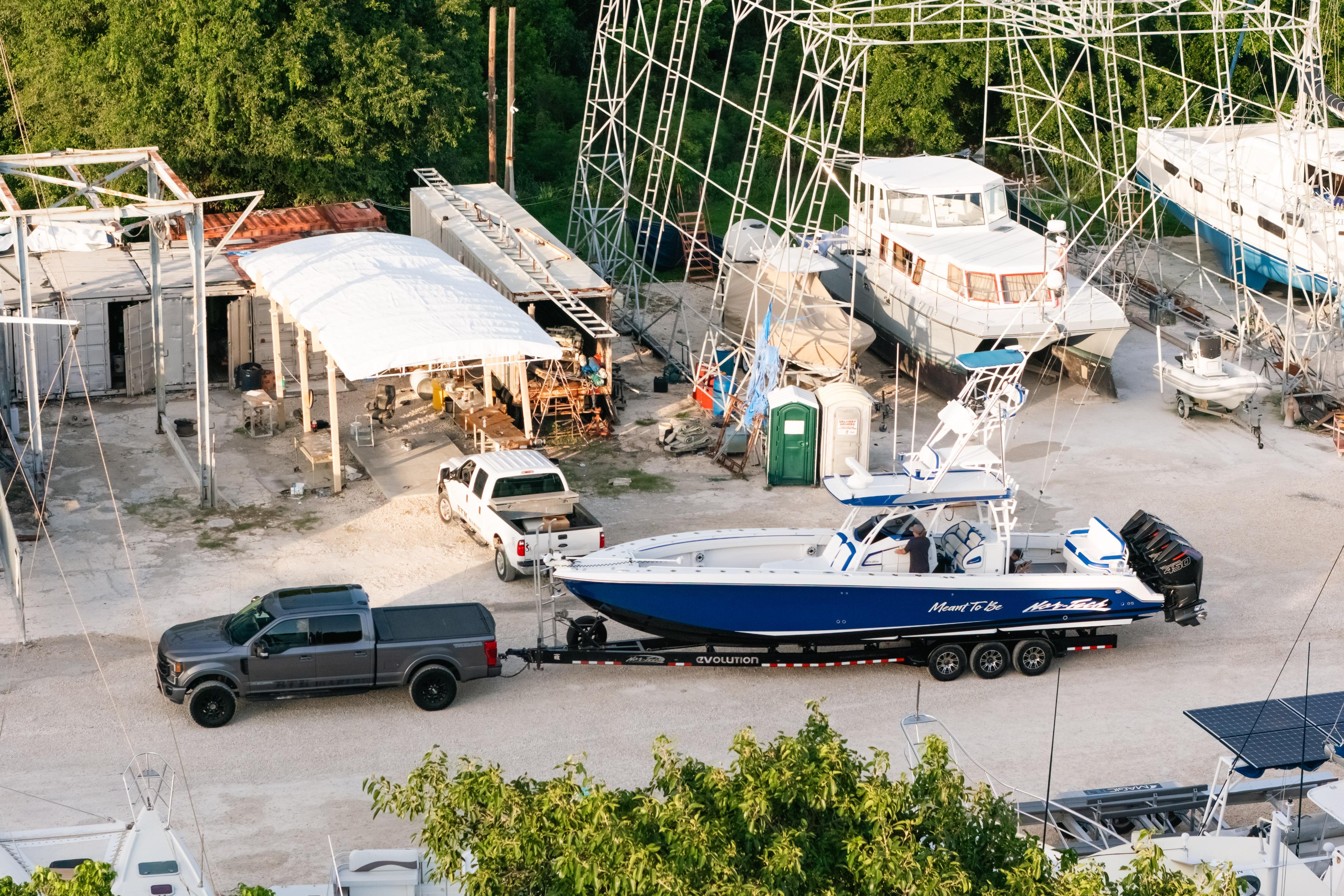 2022 Nor-Tech 392 Super Fish boat on trailer at a marina with surrounding boats.