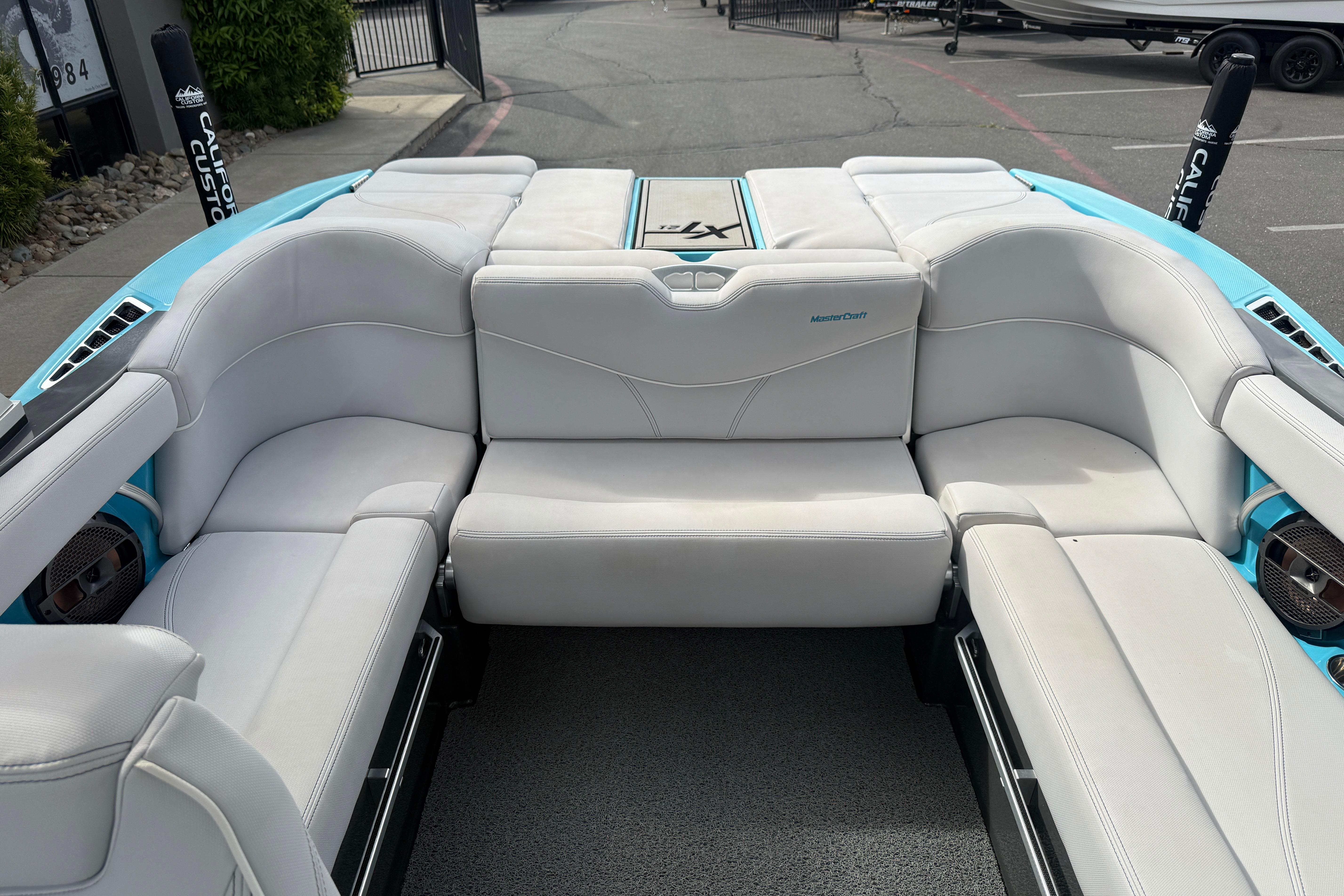 2018 MasterCraft XT21 boat interior with white seating and blue accents.