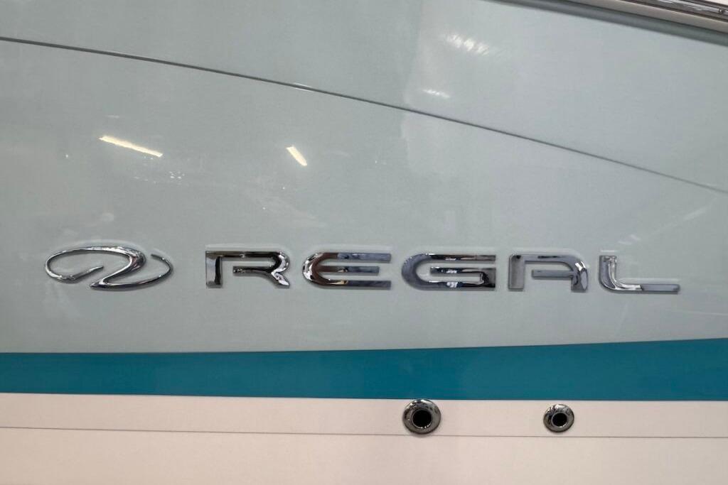 2022 Regal LS6 Surf boat logo on sleek blue and white hull.