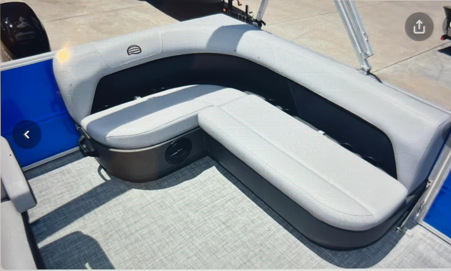 2026 Sun Tracker Party Barge 16 DLX interior seating with gray upholstery and spacious layout.