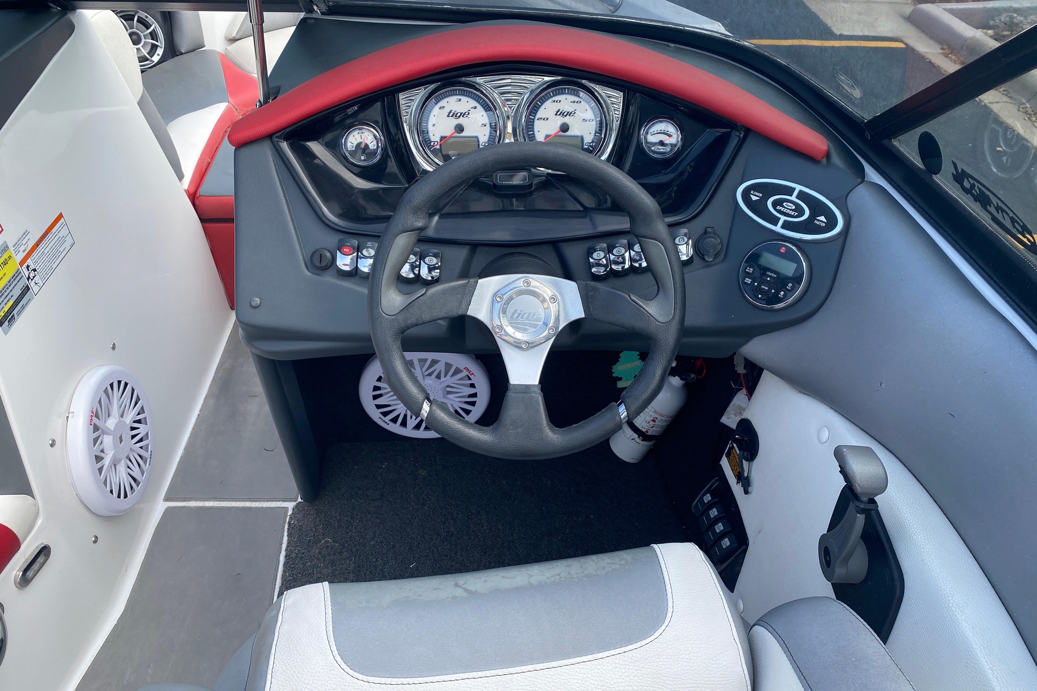 2014 Tigé R20 boat dashboard with steering wheel and control panel.