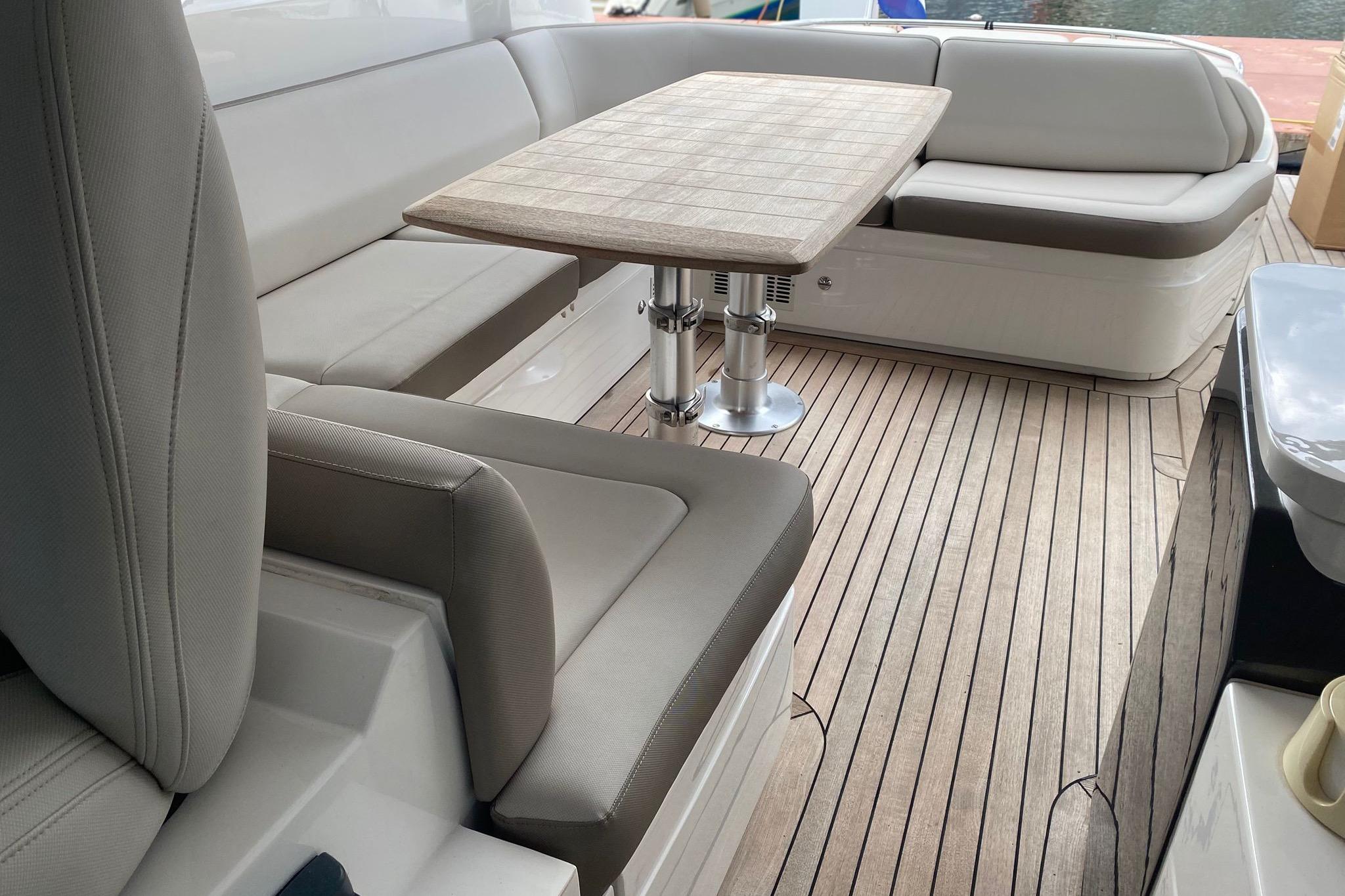 Luxurious seating area on a 2014 Princess V48 yacht with wooden flooring.