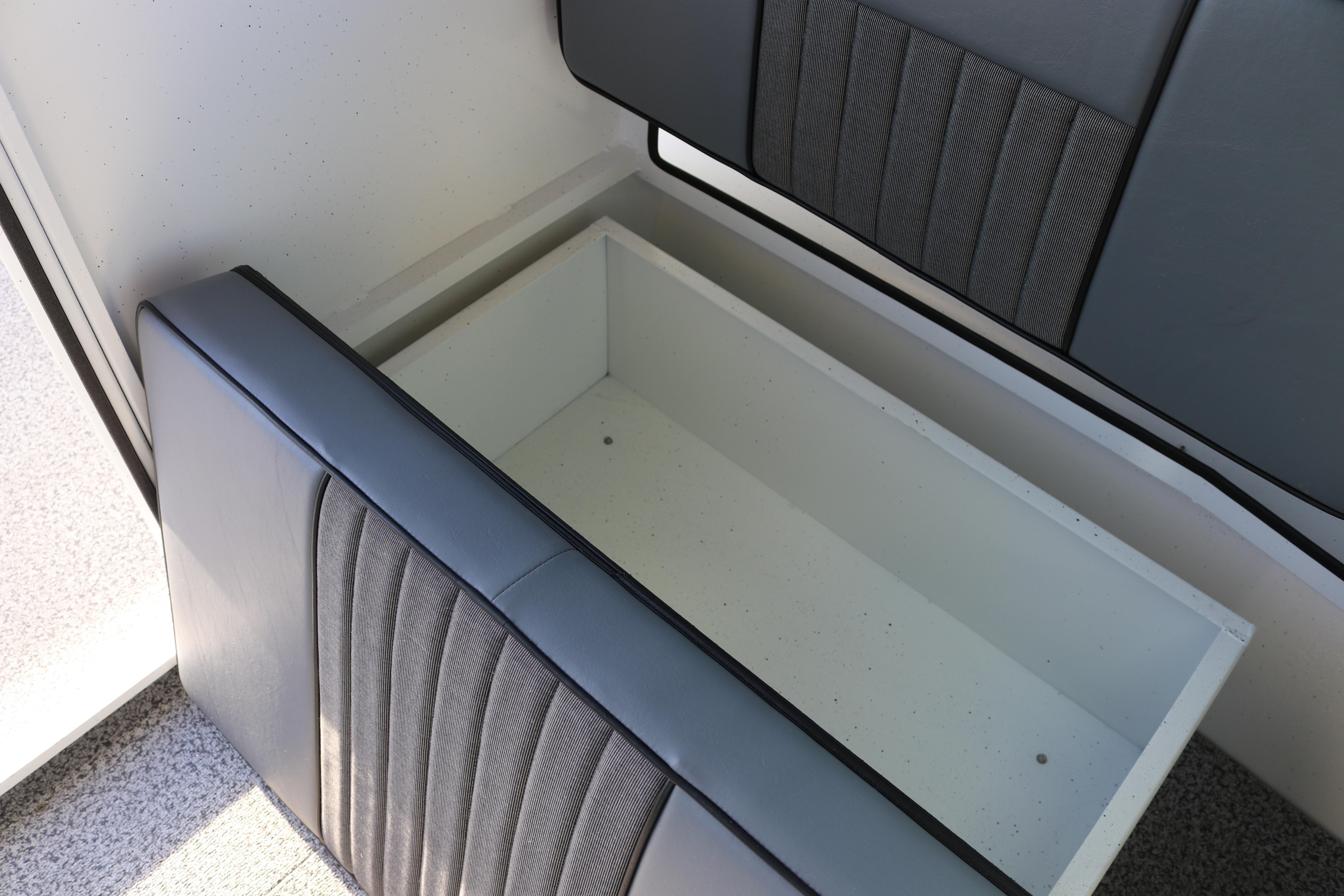 2026 Alumaweld Intruder Outboard 22 interior storage compartment with cushioned seating.