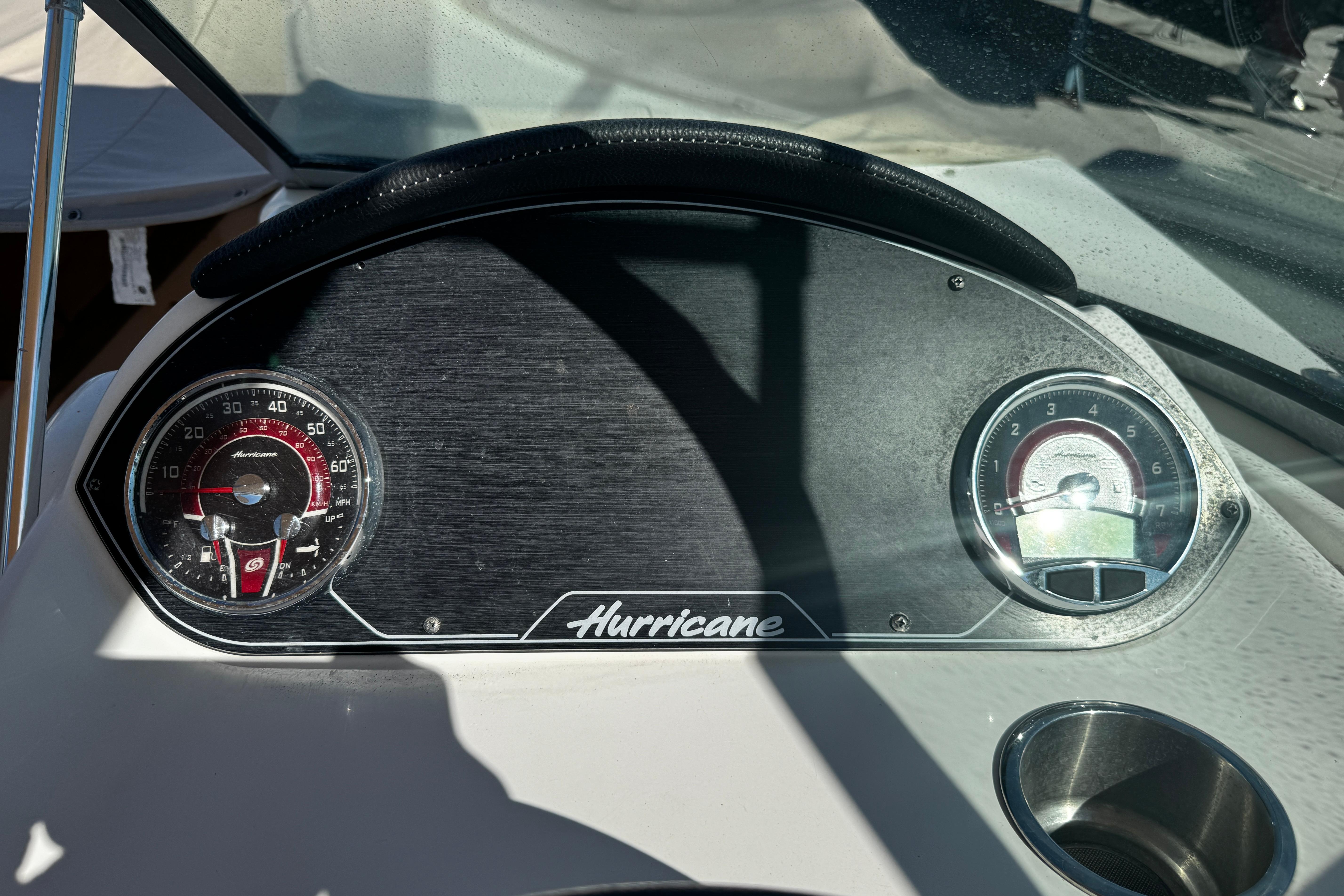 Dashboard of 2021 Hurricane SunDeck 2200 DC OB boat with gauges and logo.