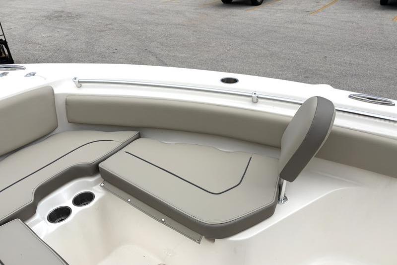 2024 Key West 239 FS boat interior with cushioned seating and cup holders.