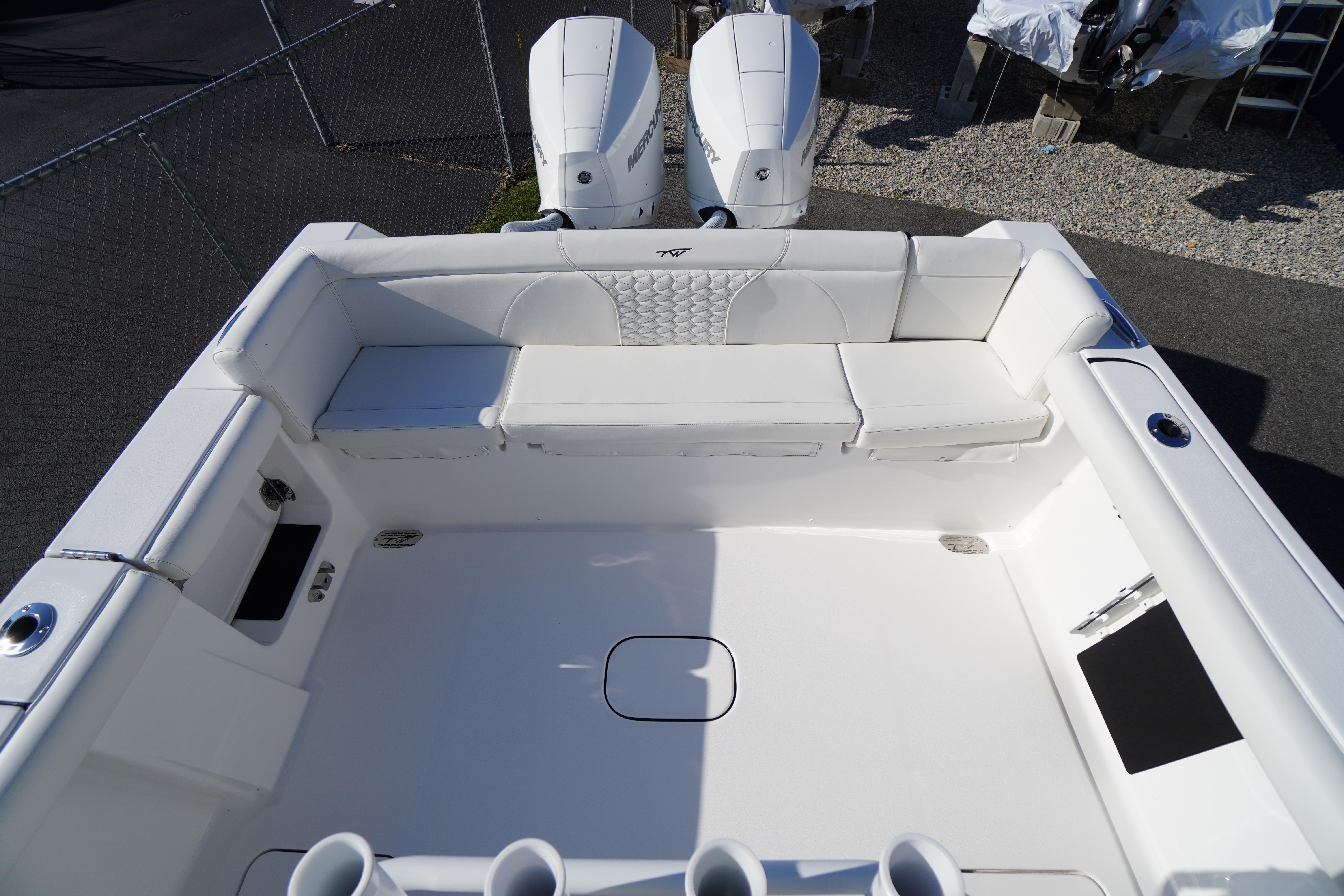 2026 Tidewater 272 LXF boat interior with white seating and dual engines.