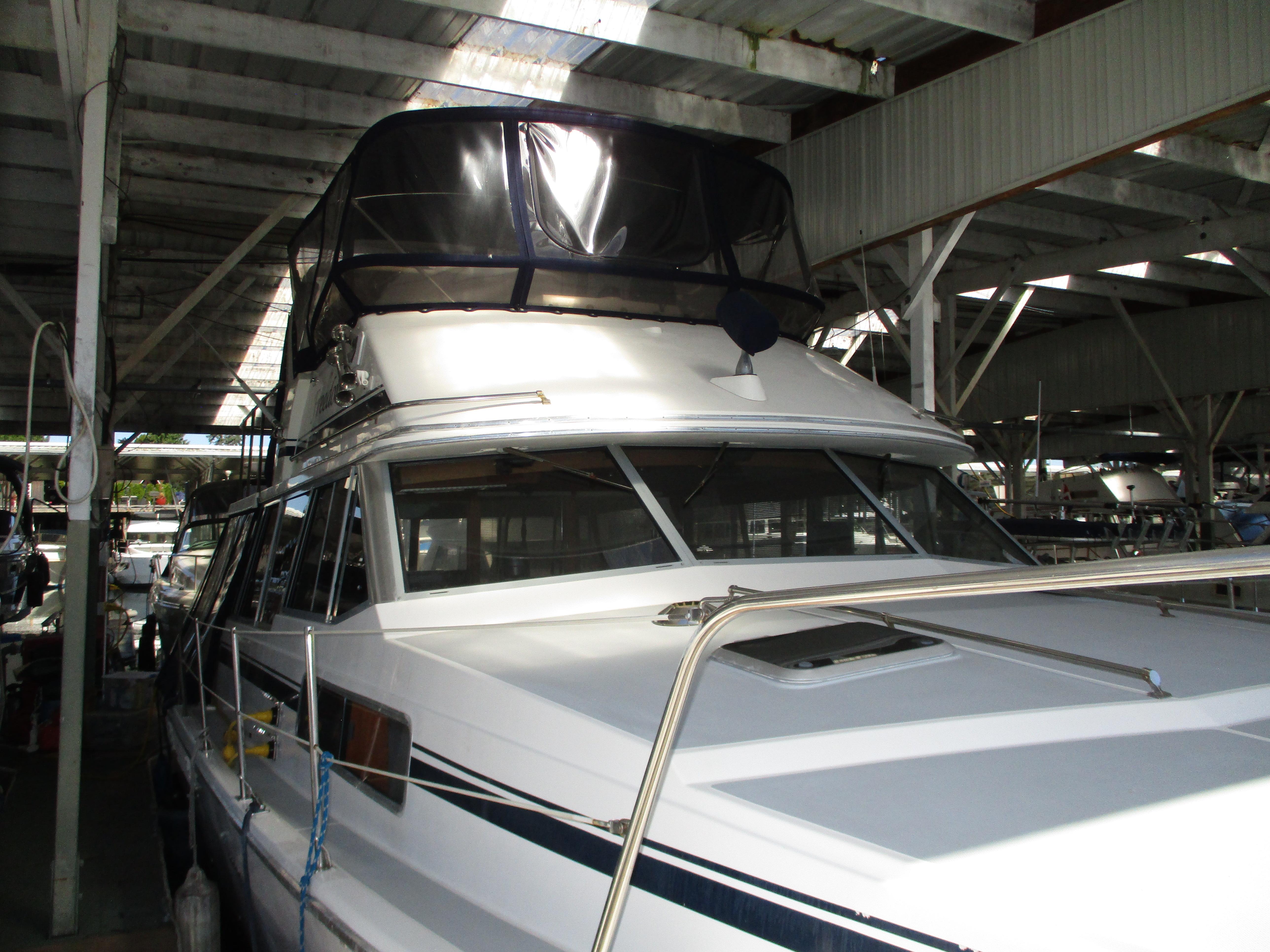 1989 Bayliner 3888 yacht docked in a covered marina.