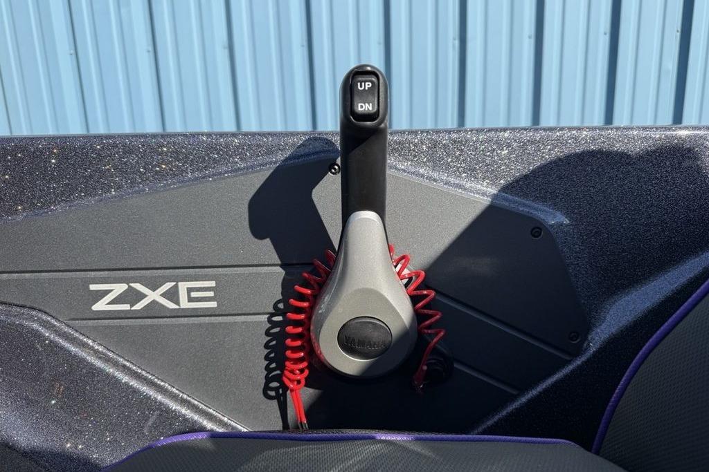 Control panel of 2026 Skeeter ZXE21 boat with throttle lever and red coiled cord.