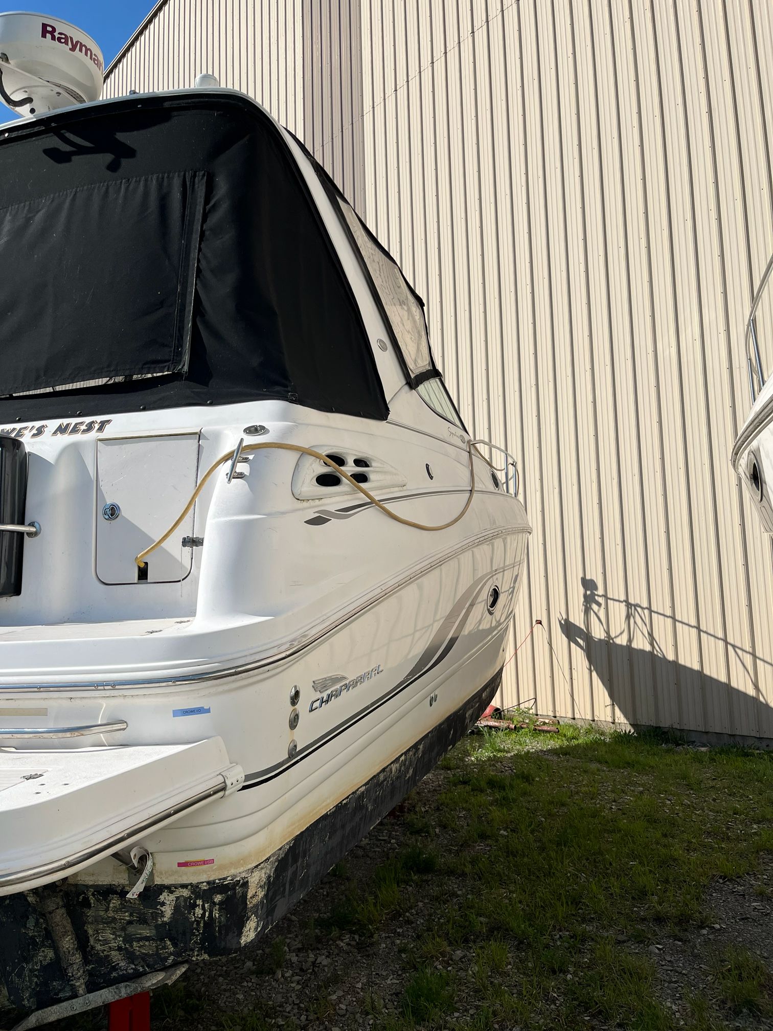 Chaparral Signature 2000 boat parked beside building.