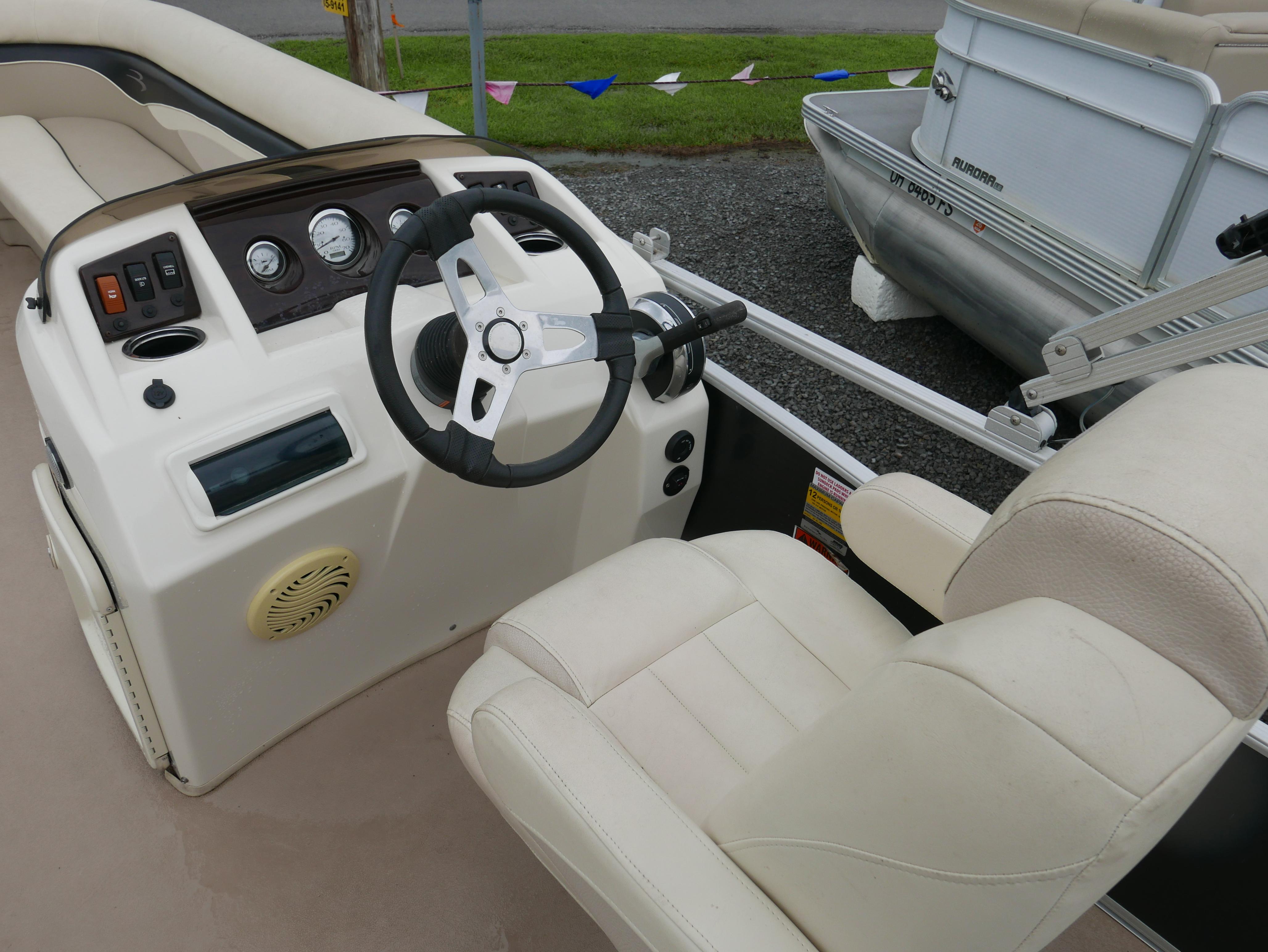 2013 Bennington 22SLX boat interior with steering wheel and control panel.