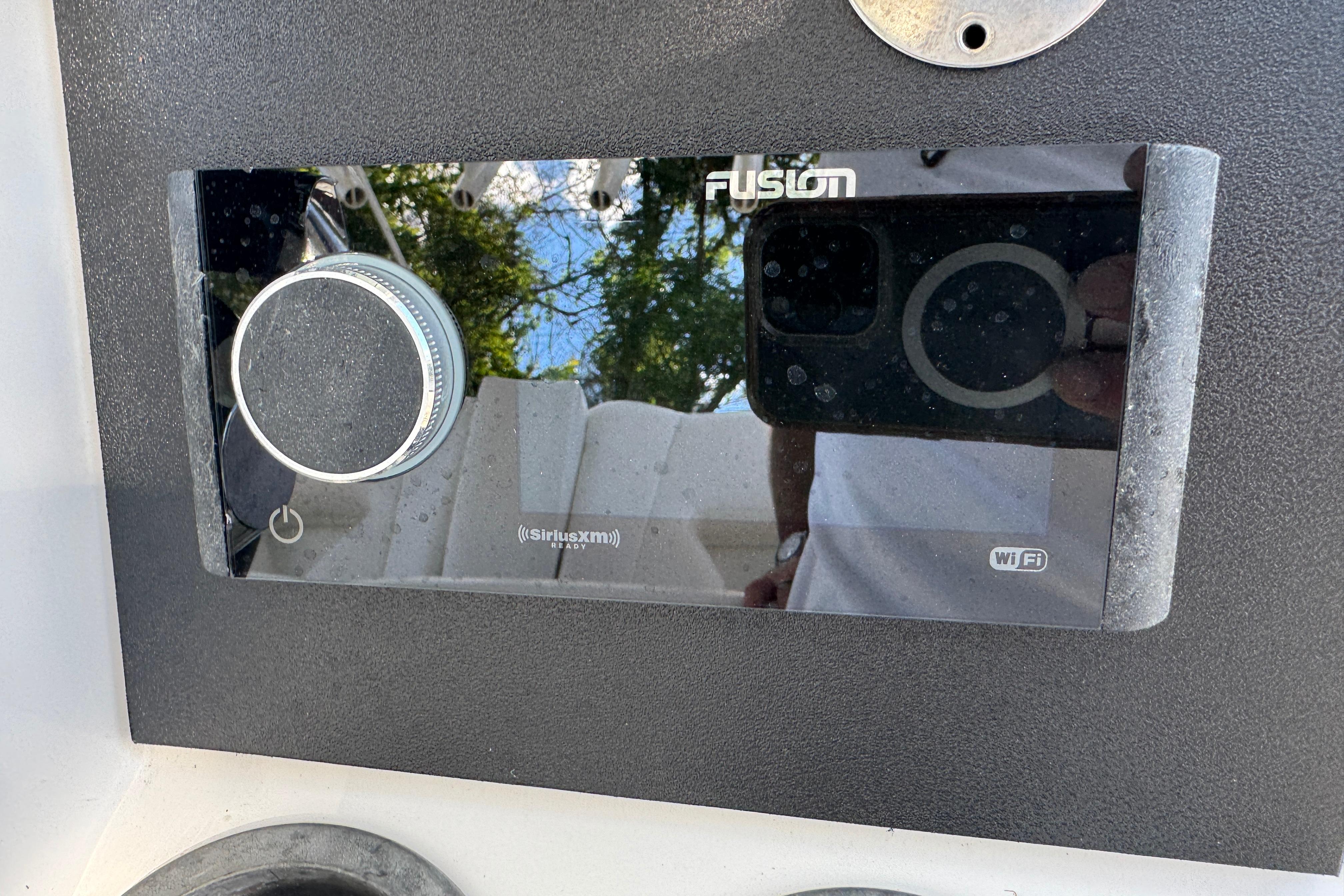 Fusion stereo system on a 2014 Boston Whaler 250 Outrage boat dashboard.