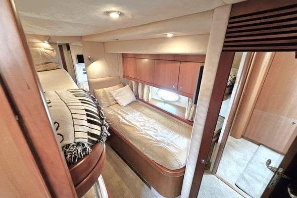 Luxurious cabin interior of 2005 Sunseeker Manhattan 66 yacht with cozy bedding.