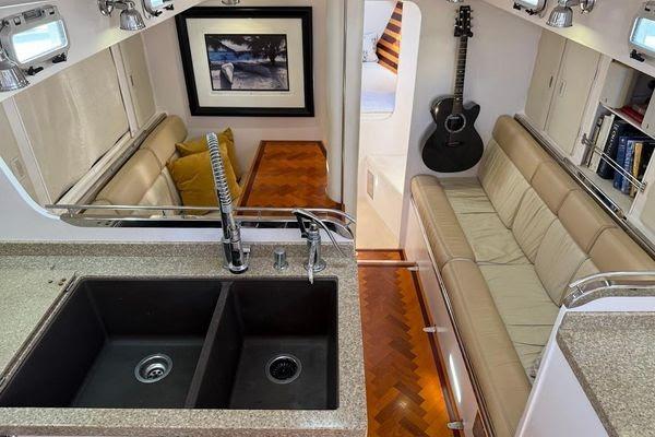 Luxurious interior of 2011 Reliance 44 yacht with modern kitchen and cozy seating area.